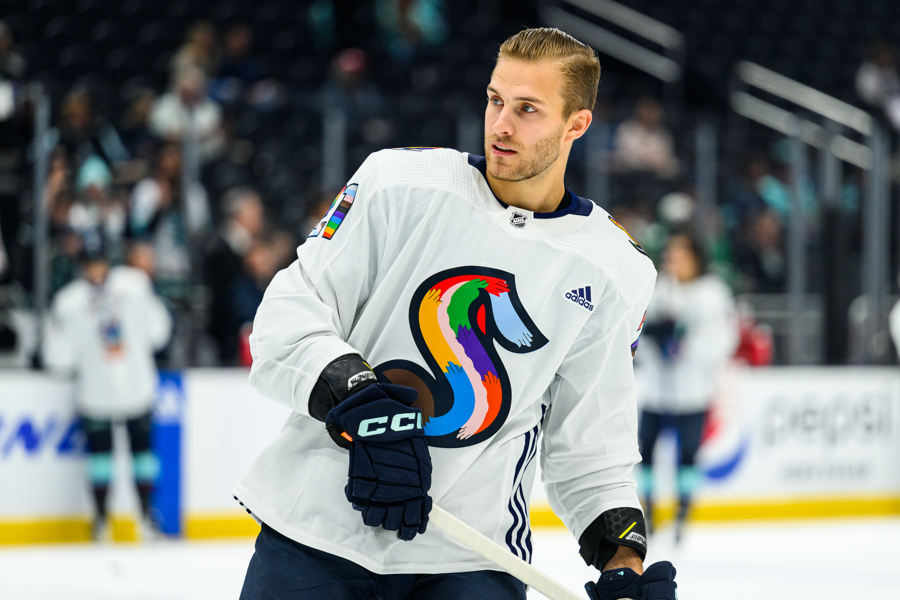 Alex Wennberg of the Seattle Kraken skates on the ice during warmups in his special Pride Night jersey