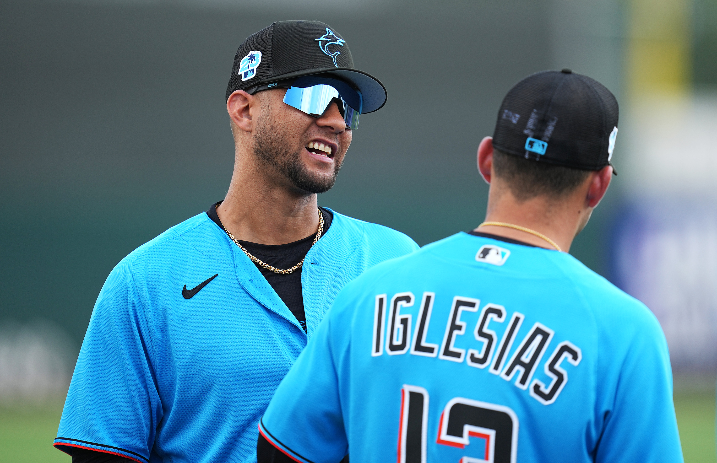 Miami Marlins designated hitter Yuli Gurriel (97) talks with Miami Marlins shortstop Jose Iglesias (13) before the game against the New York Mets at Roger Dean Stadium.