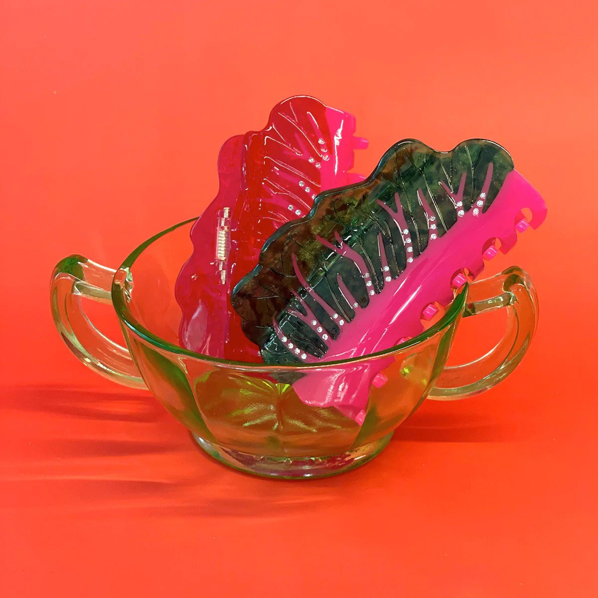 Two claw clips designed to look like Swiss chard in a cup