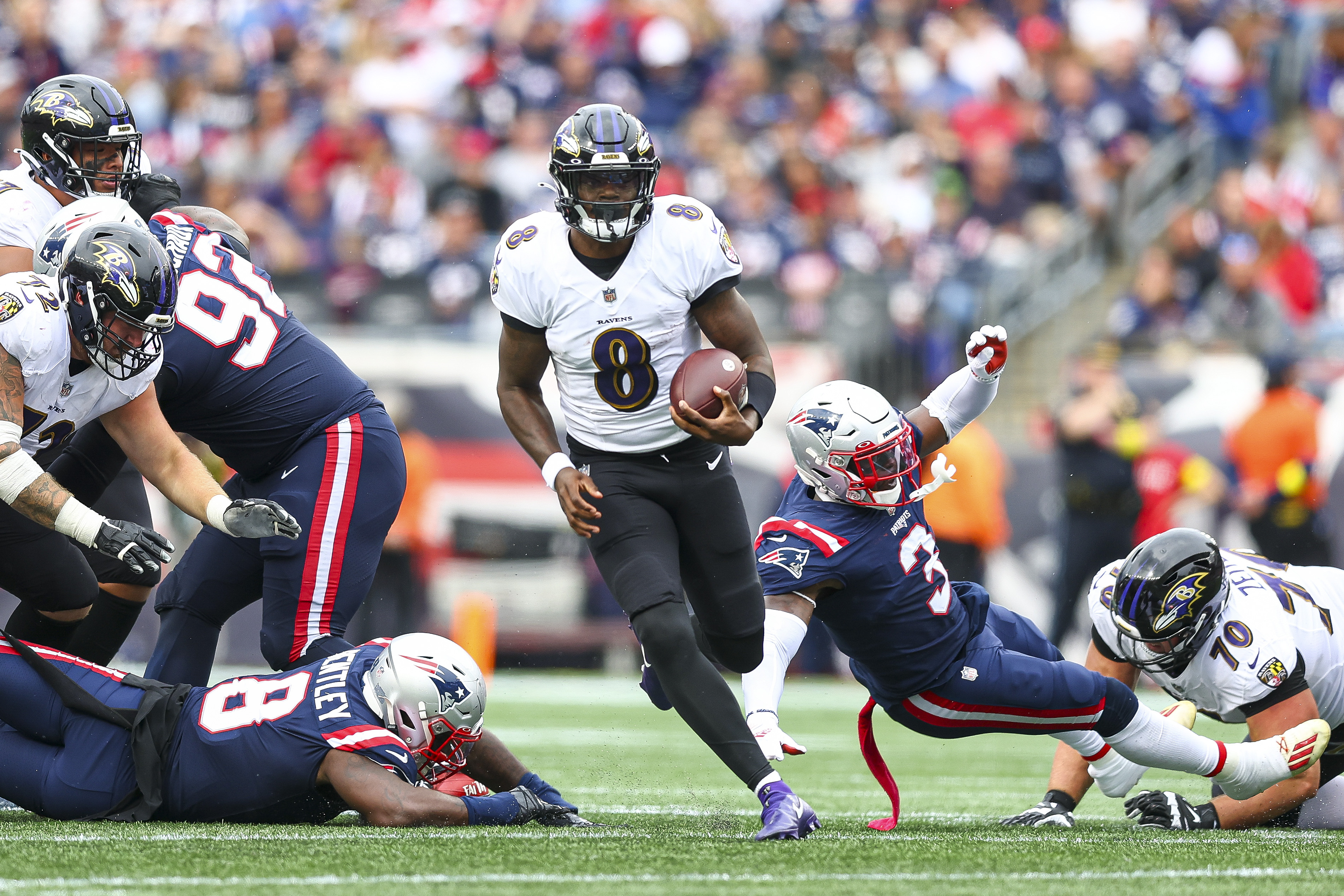 Quarterback Lamar Jackson of the Baltimore Ravens runs the ball during the second half against the New England Patriots at Gillette Stadium on September 25, 2022 in Foxborough, Massachusetts.