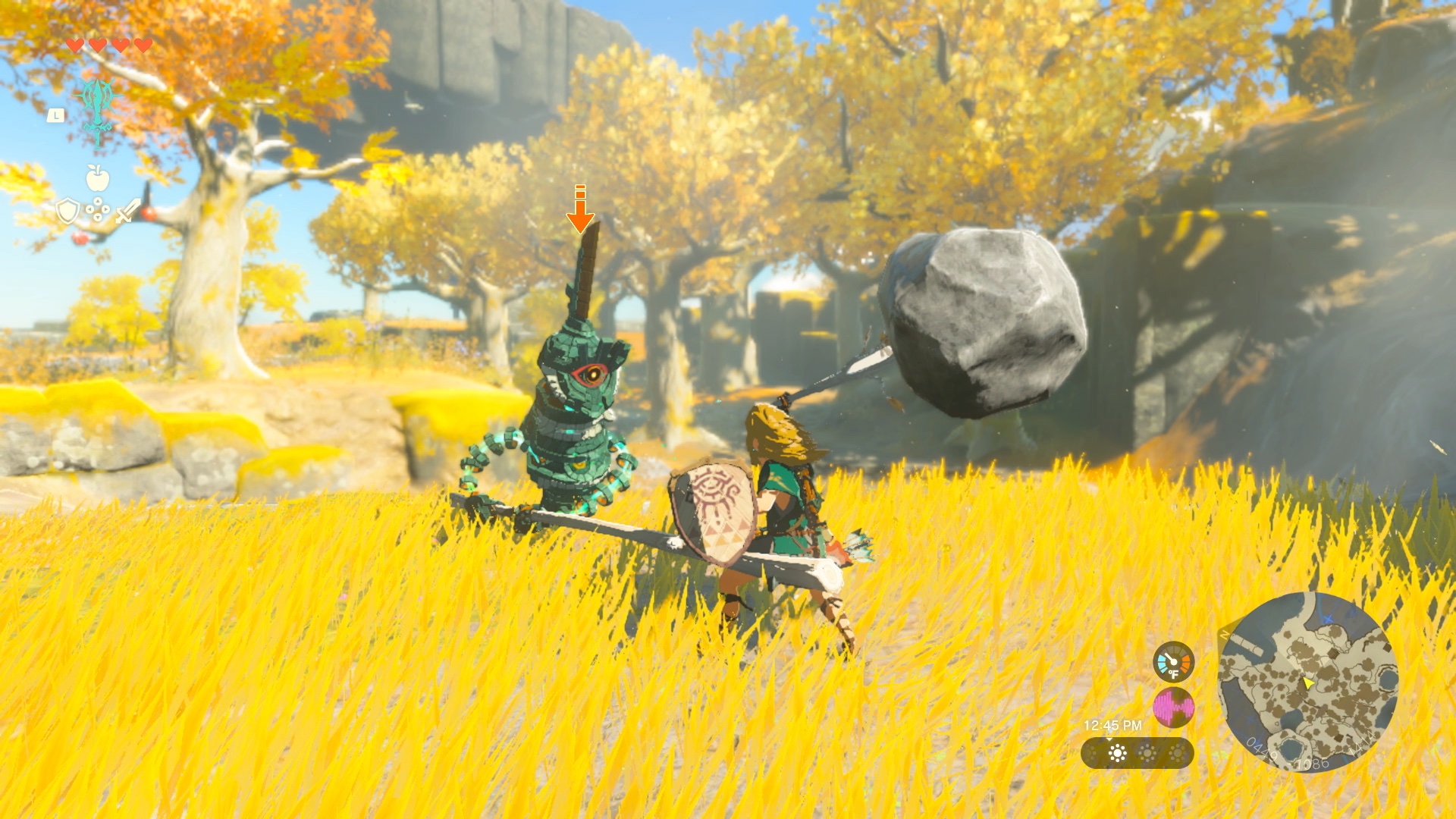 Link strikes a Construct with a makeshift hammer made of a stick and boulder in a screenshot from The Legend of Zelda: Tears of the Kingdom