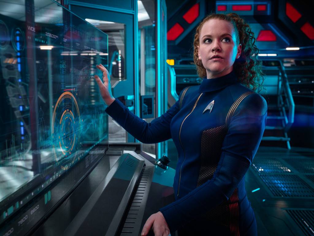 Lieutenant Sylvia Tilly in her blue Starfleet uniform operating an engineering console in Star Trek: Discovery