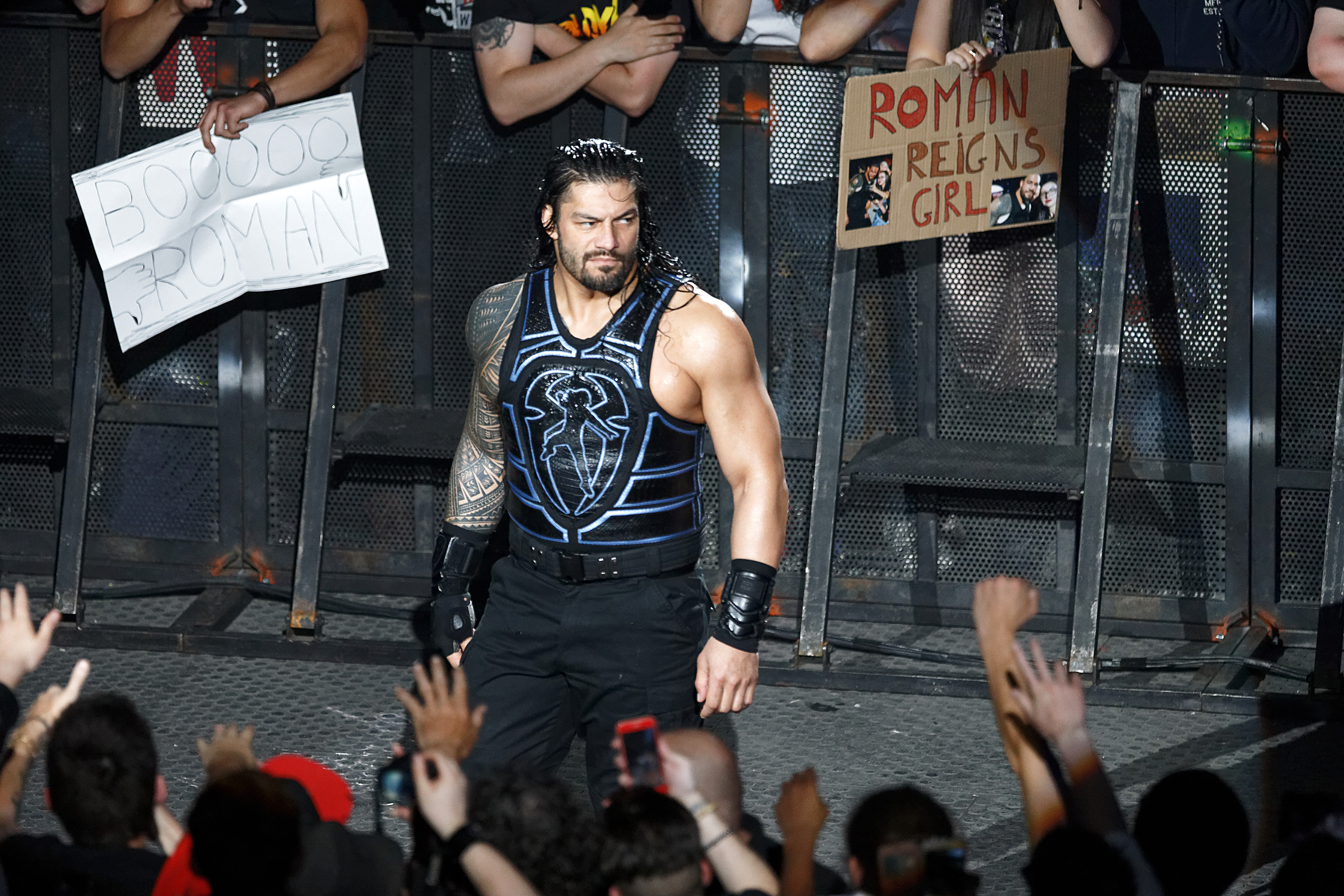 Roman Reigns walks through fans booing and cheering at the WWE Live Paris At Accorhotels Arena In Paris