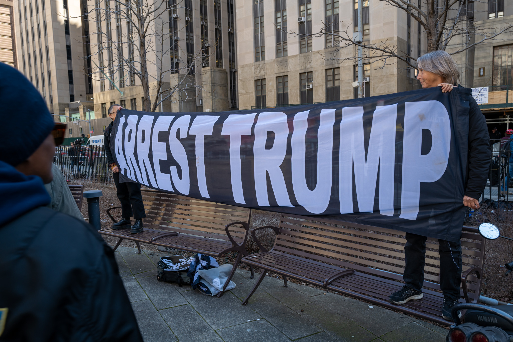 People gather outside of a Manhattan courthouse as the nation waits for the possibility of an indictment against former president Donald Trump by the Manhattan District Attorney Alvin Bragg’s office on March 21, 2023 in New York City.