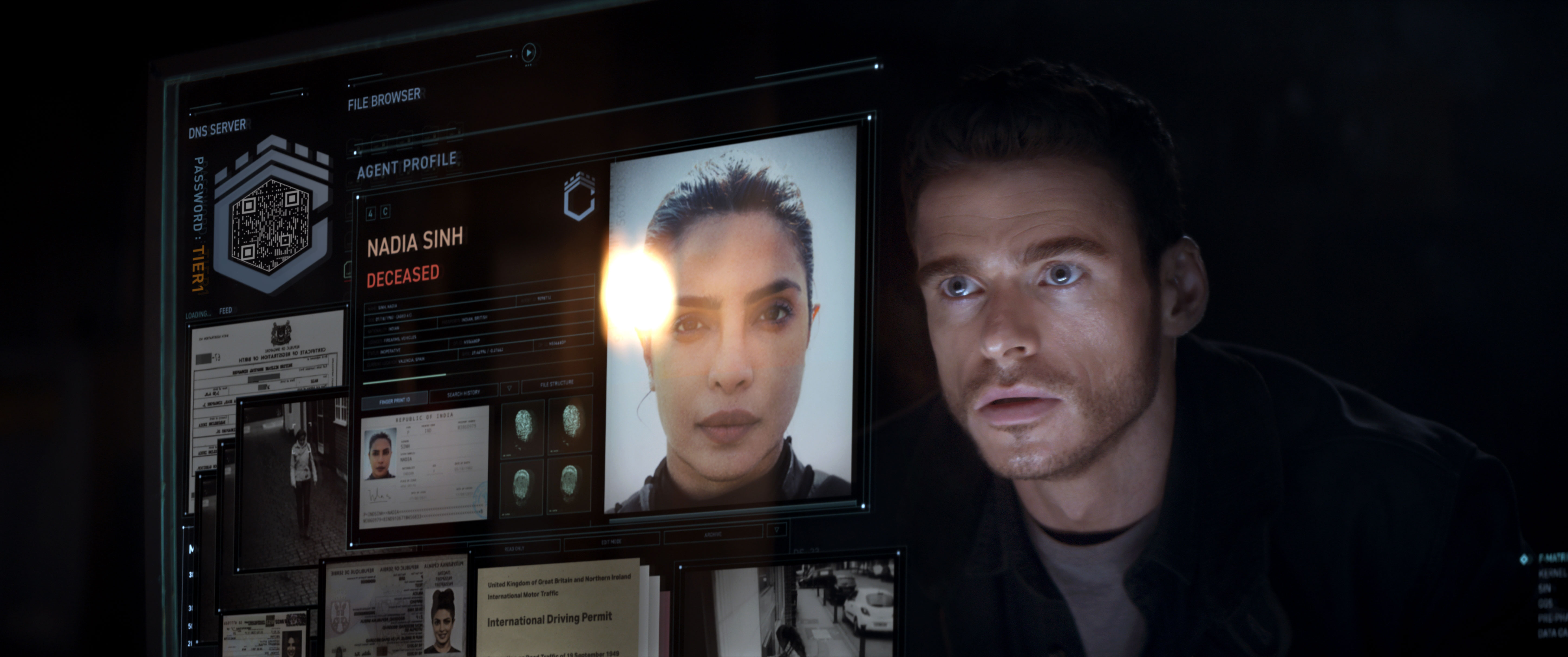 Richard Madden’s character looks at a holographic screen, on which a photograph of Priyanka Chopra Jonas’ character is visible.