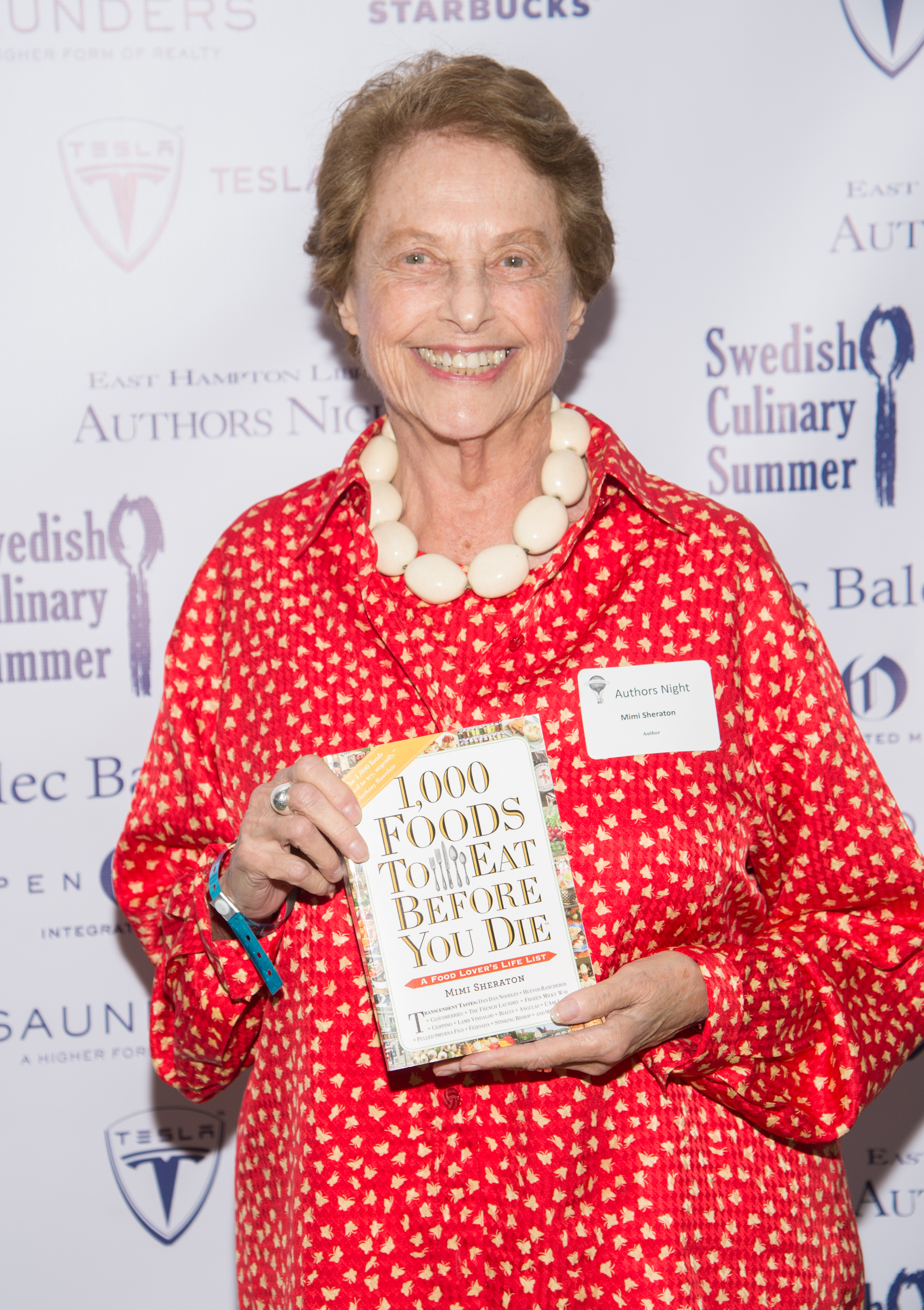 Mimi Sheraton posing with “1,000 Foods to Eat Before You Die”