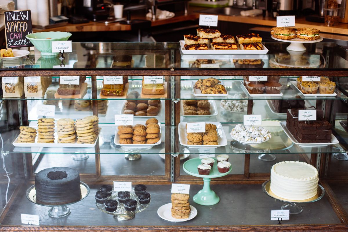 The glass pastry case at Ovenly, filled with cakes, cookies, and other sweets.