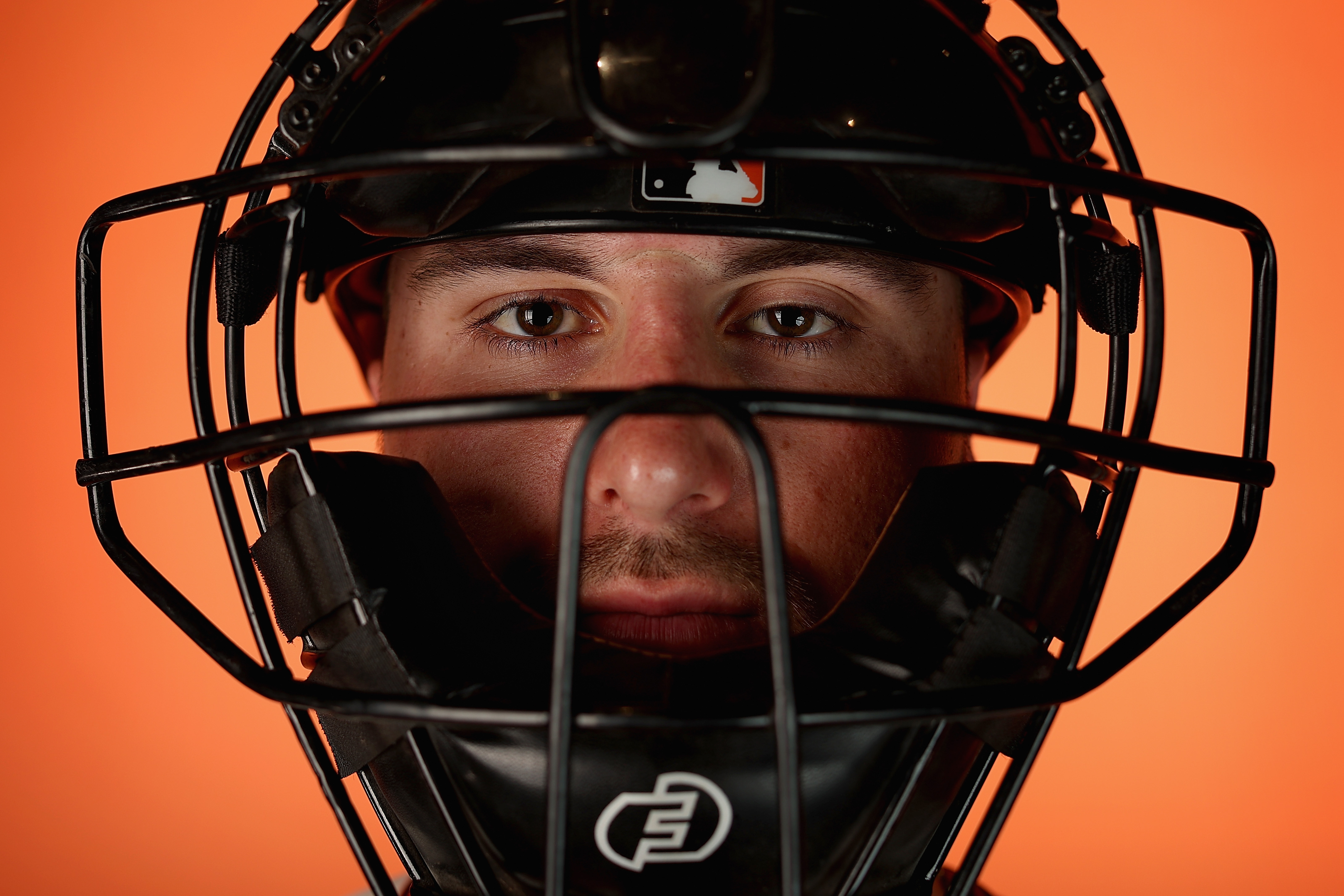 Close up of Joey Bart wearing a catcher’s mask at photo day