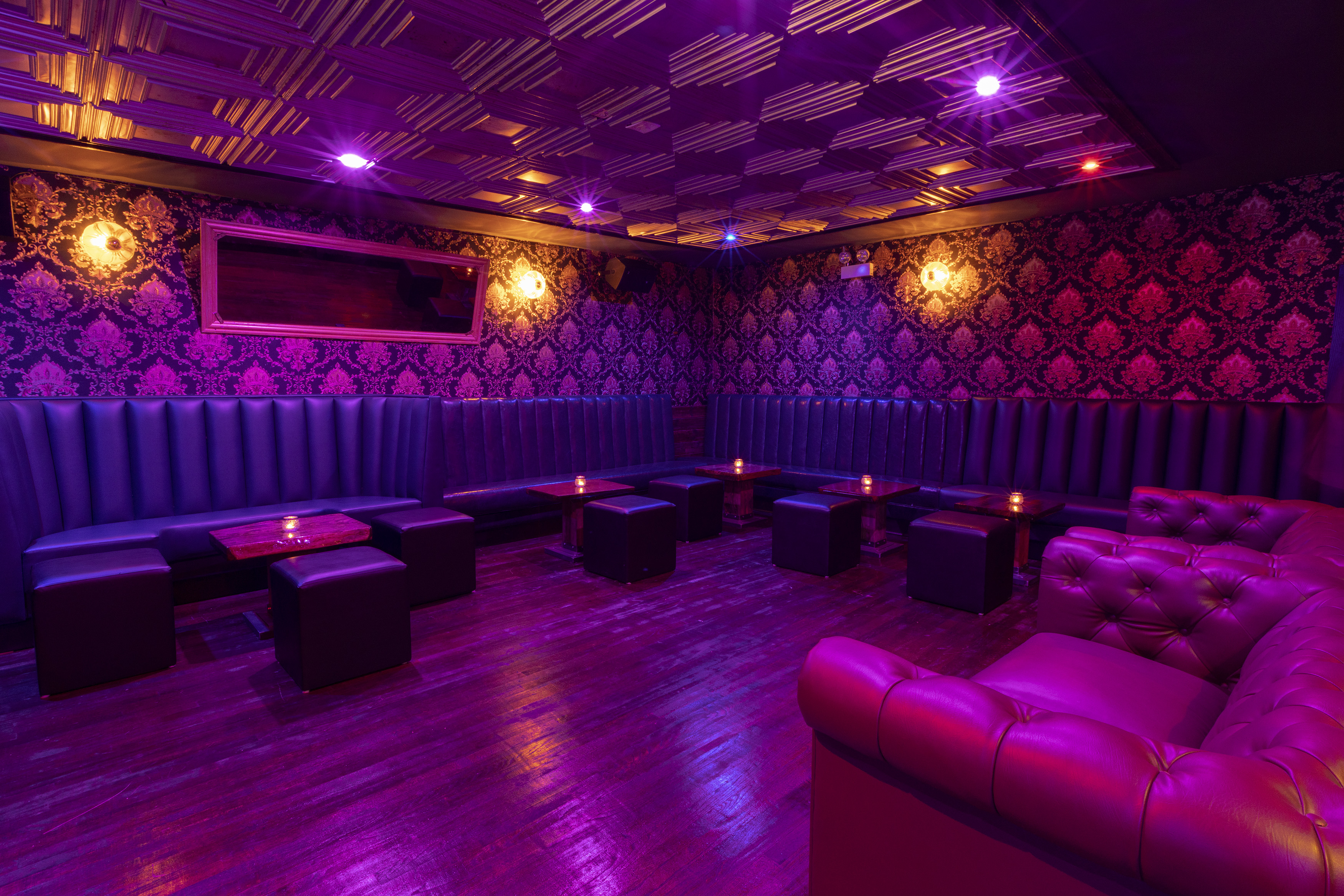 A low-lit speakeasy-style bar space.