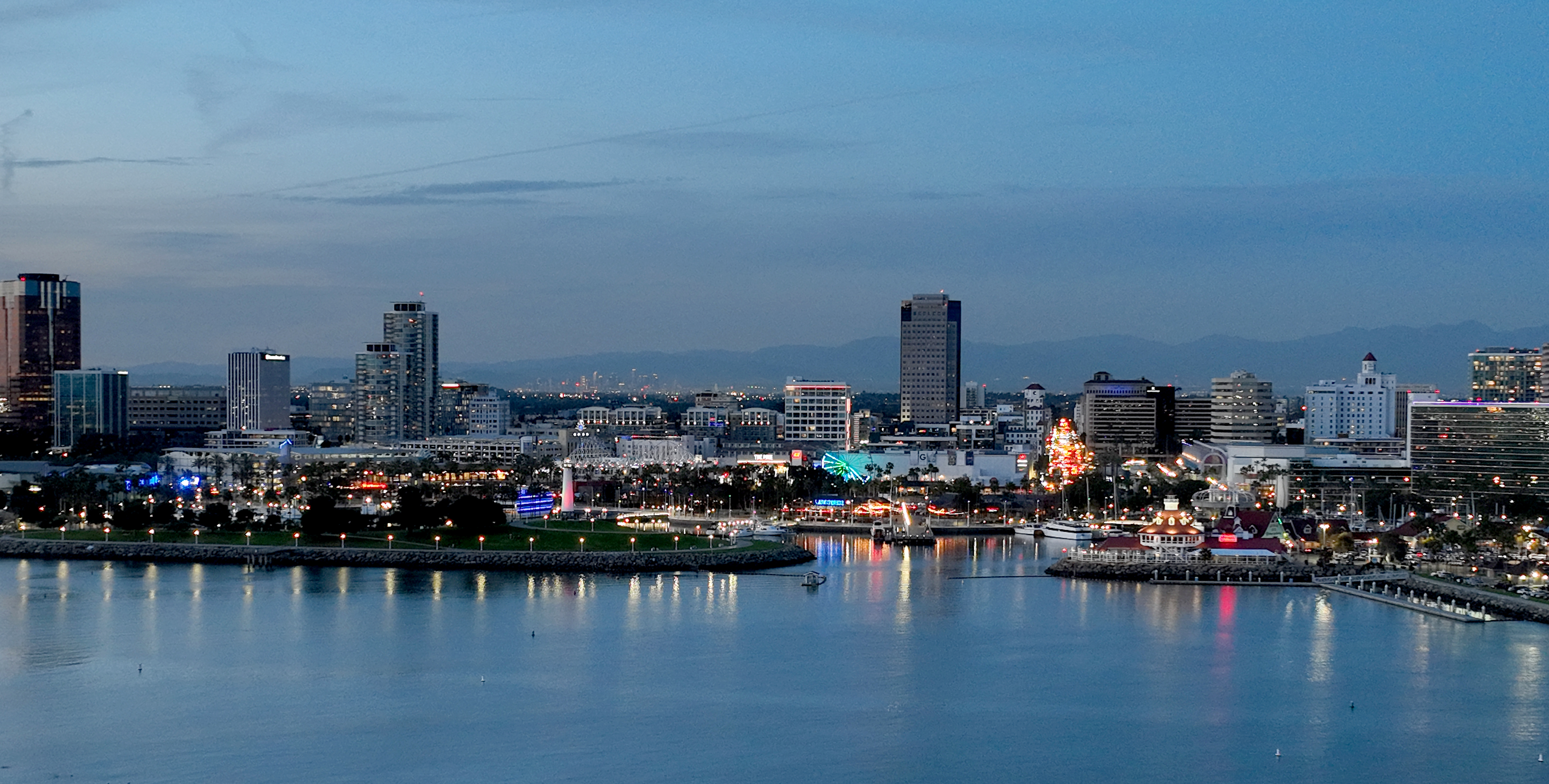 An aerial view of the Shoreline Aquatic Park, Downtown Long Beach and Rainbow Harbor in Long Beach at dusk