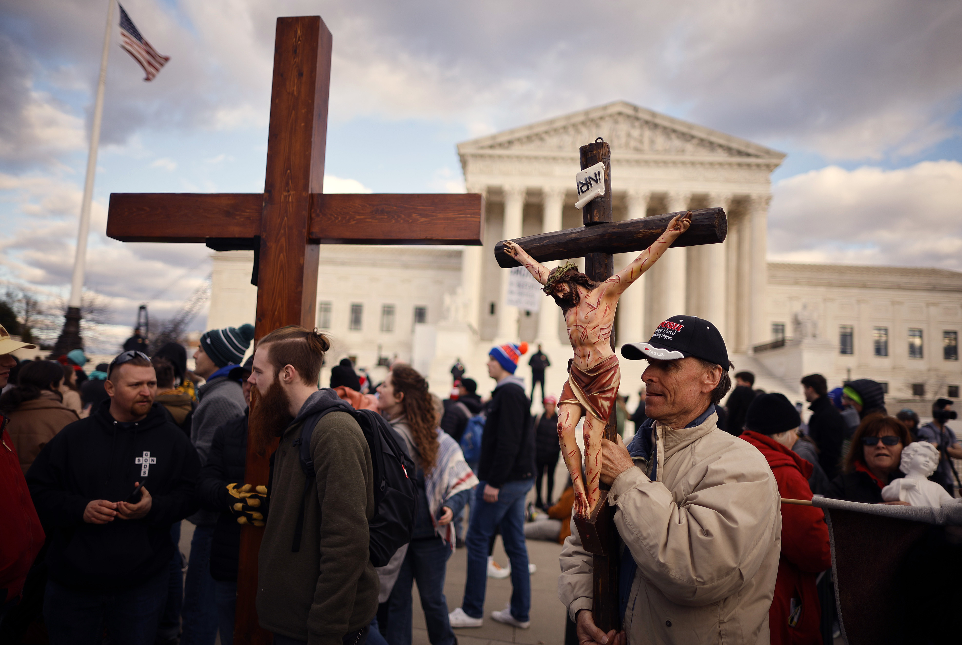 People carrying Christian religious symbols in front of the Supreme Court building.