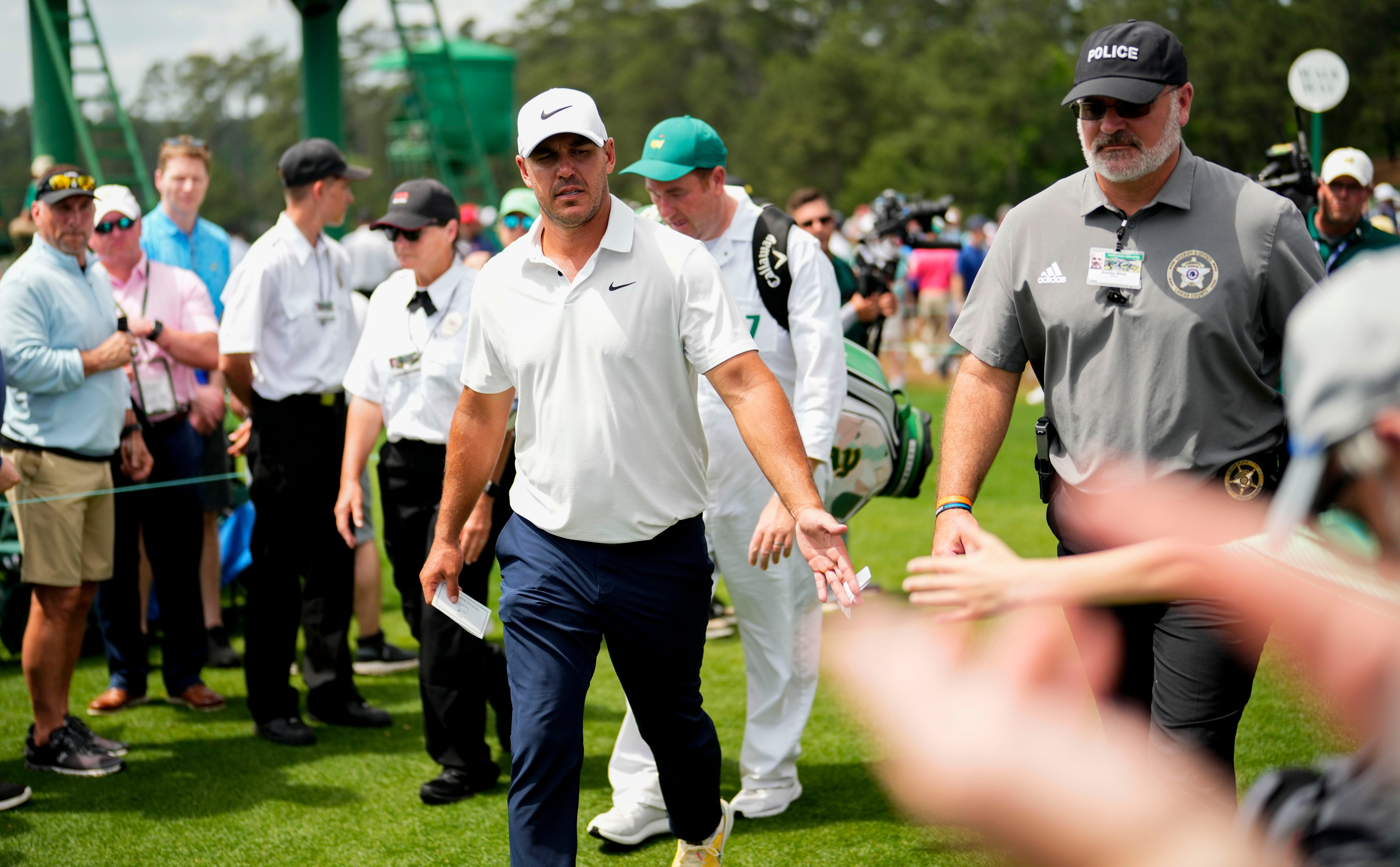 Brooks Koepka greets patrons after finishing his round during the second round of The Masters golf tournament at the Augusta National Golf Club in Augusta, Ga., on April 7, 2023.