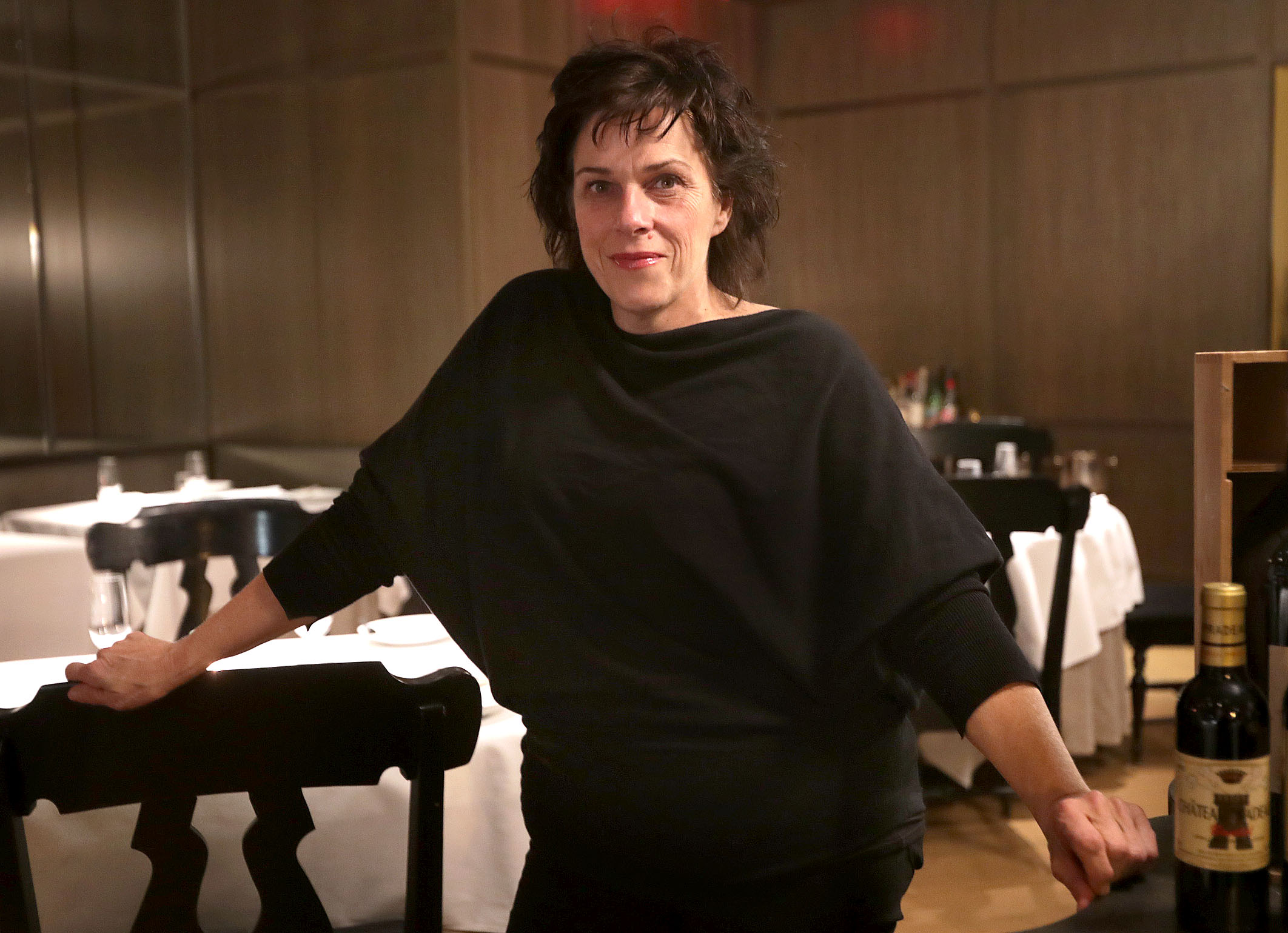 Barbara Lynch stands in a dining room.