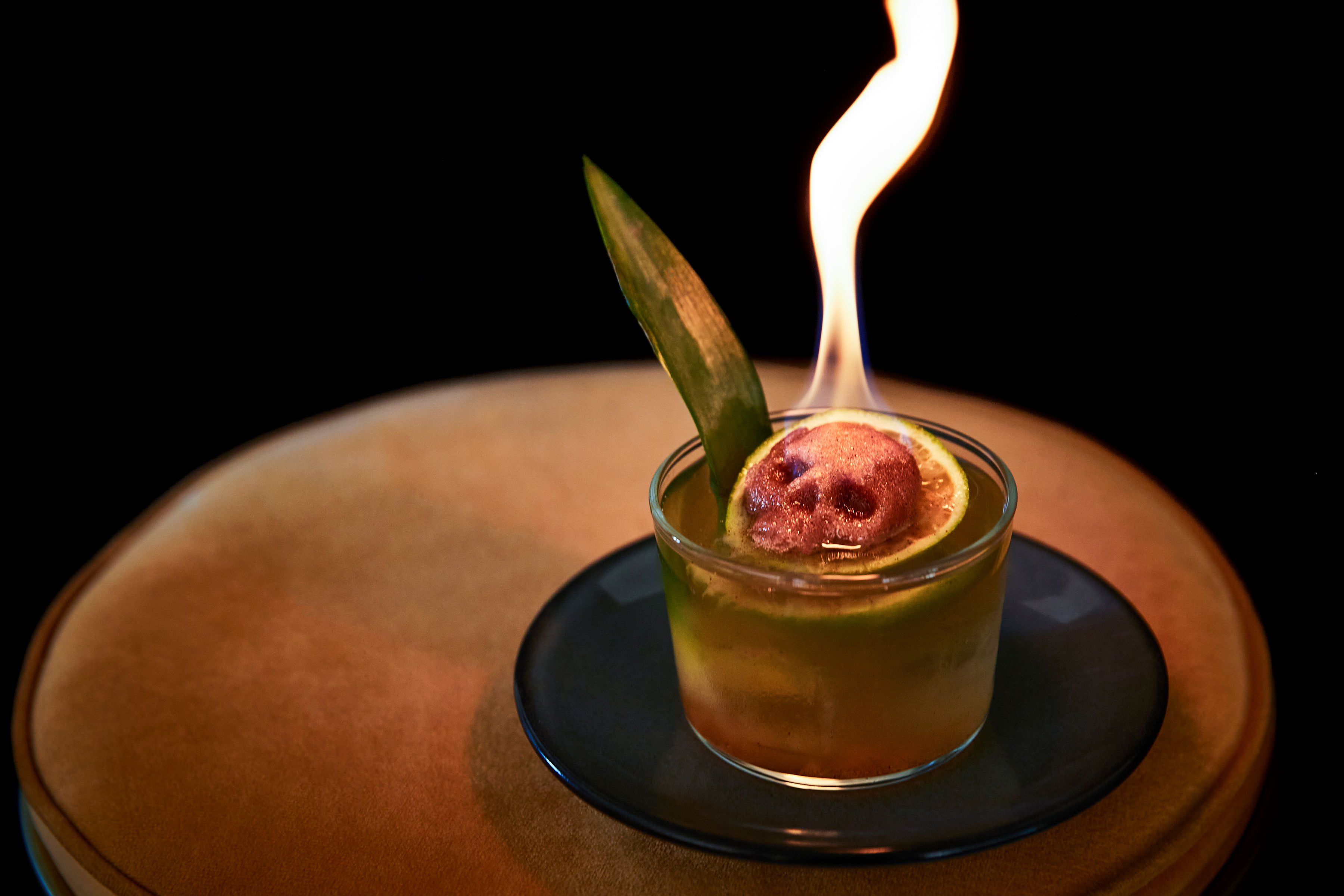 A cocktail lit on fire.