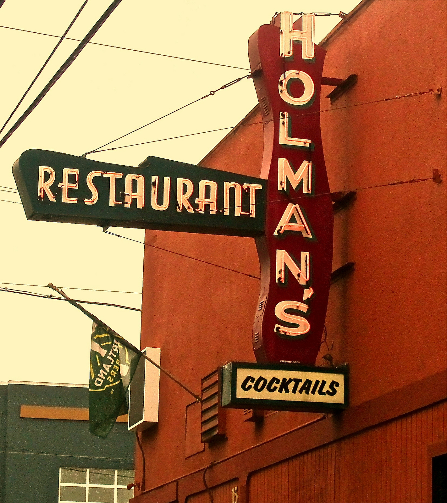 A neon sign outside Holman’s Bar &amp; Grill.