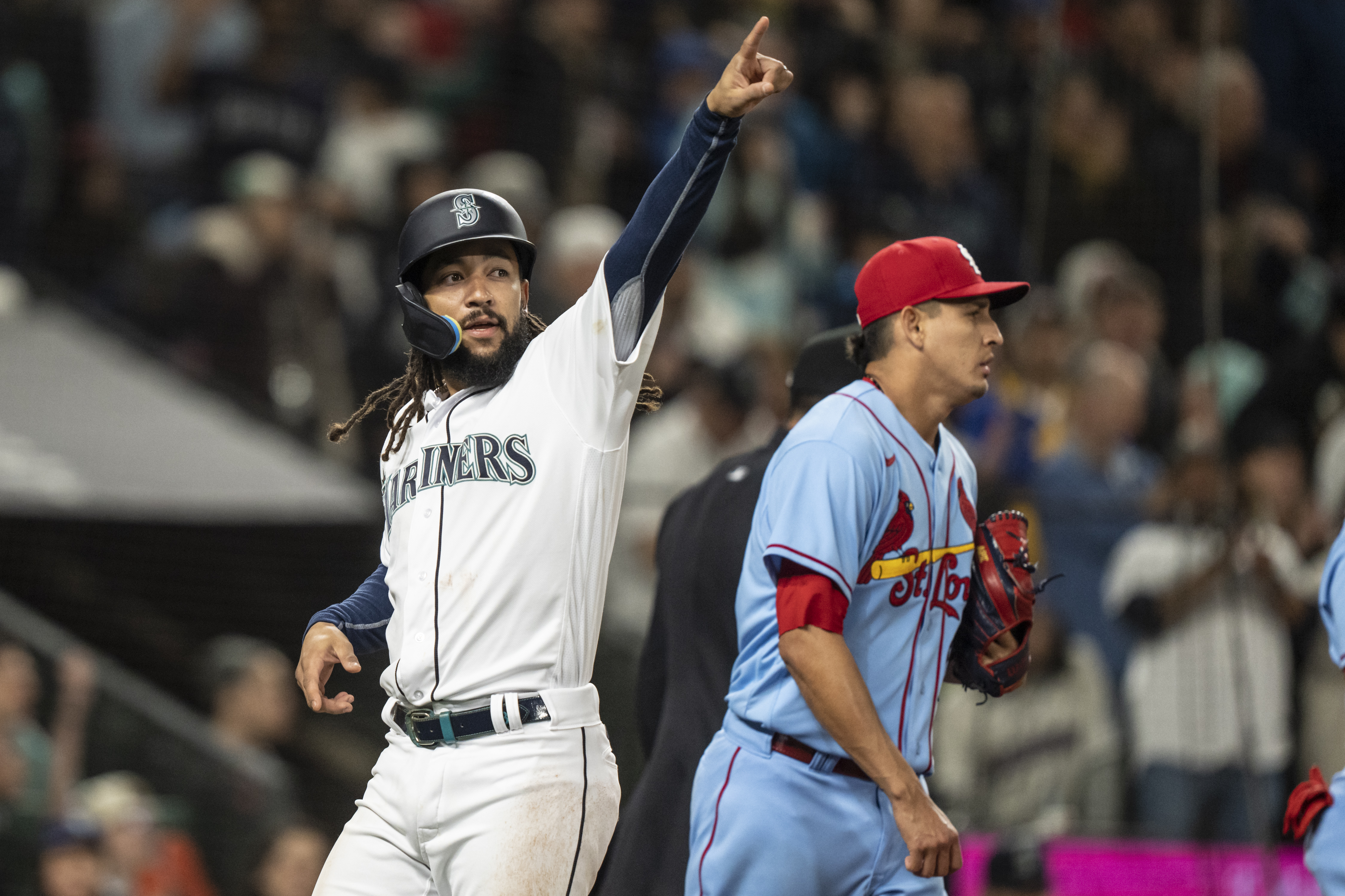 Seattle Mariners shortstop J.P. Crawford (3) gestures to third baseman Eugenio Suarez (28) after scoring a run during the seventh inning against the St. Louis Cardinals at T-Mobile Park.