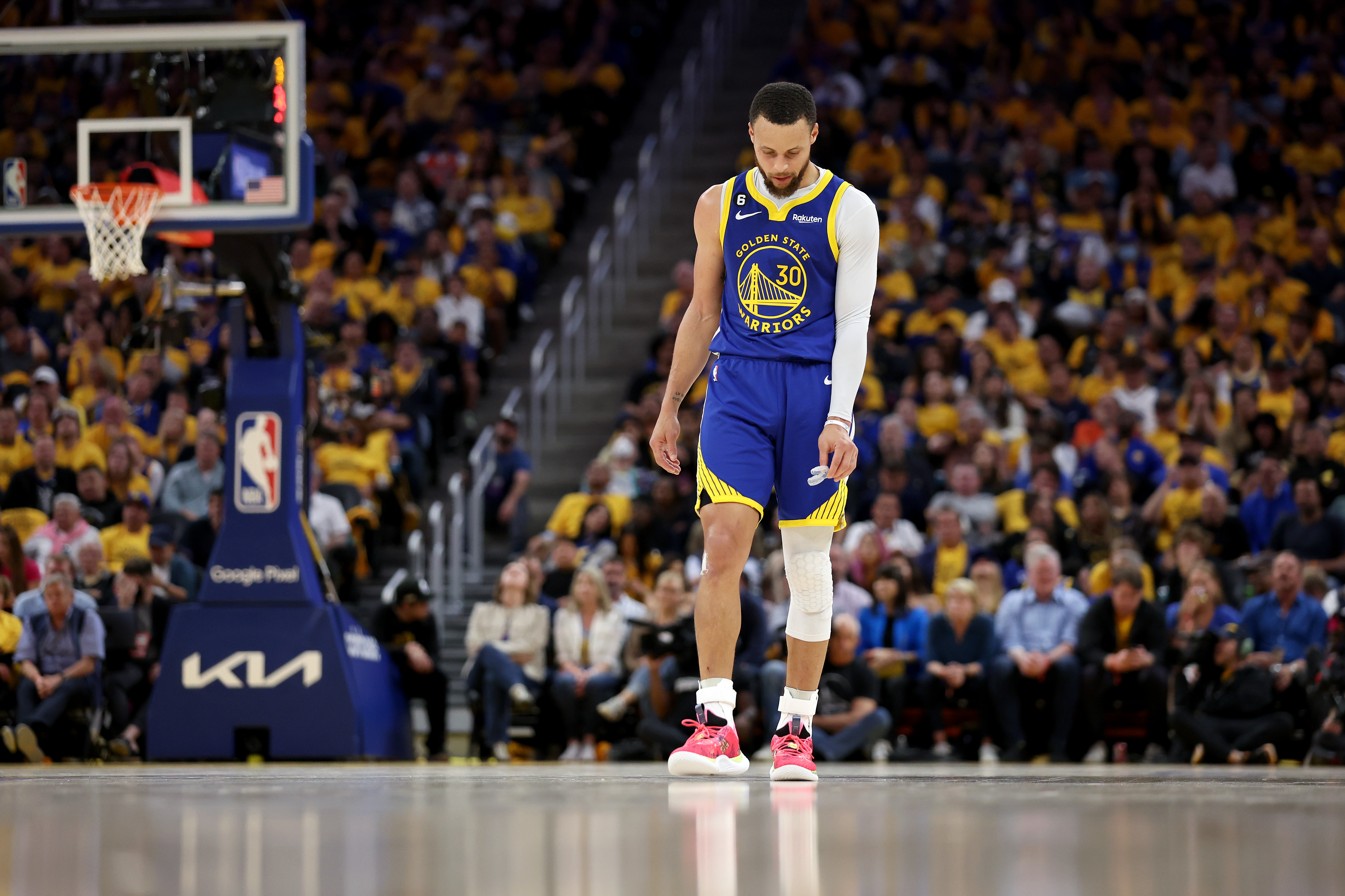 Steph Curry walking off the court, dejected