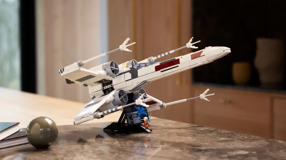 A stock photo of the 2023 Lego X-Wing model assembled on a kitchen counter.