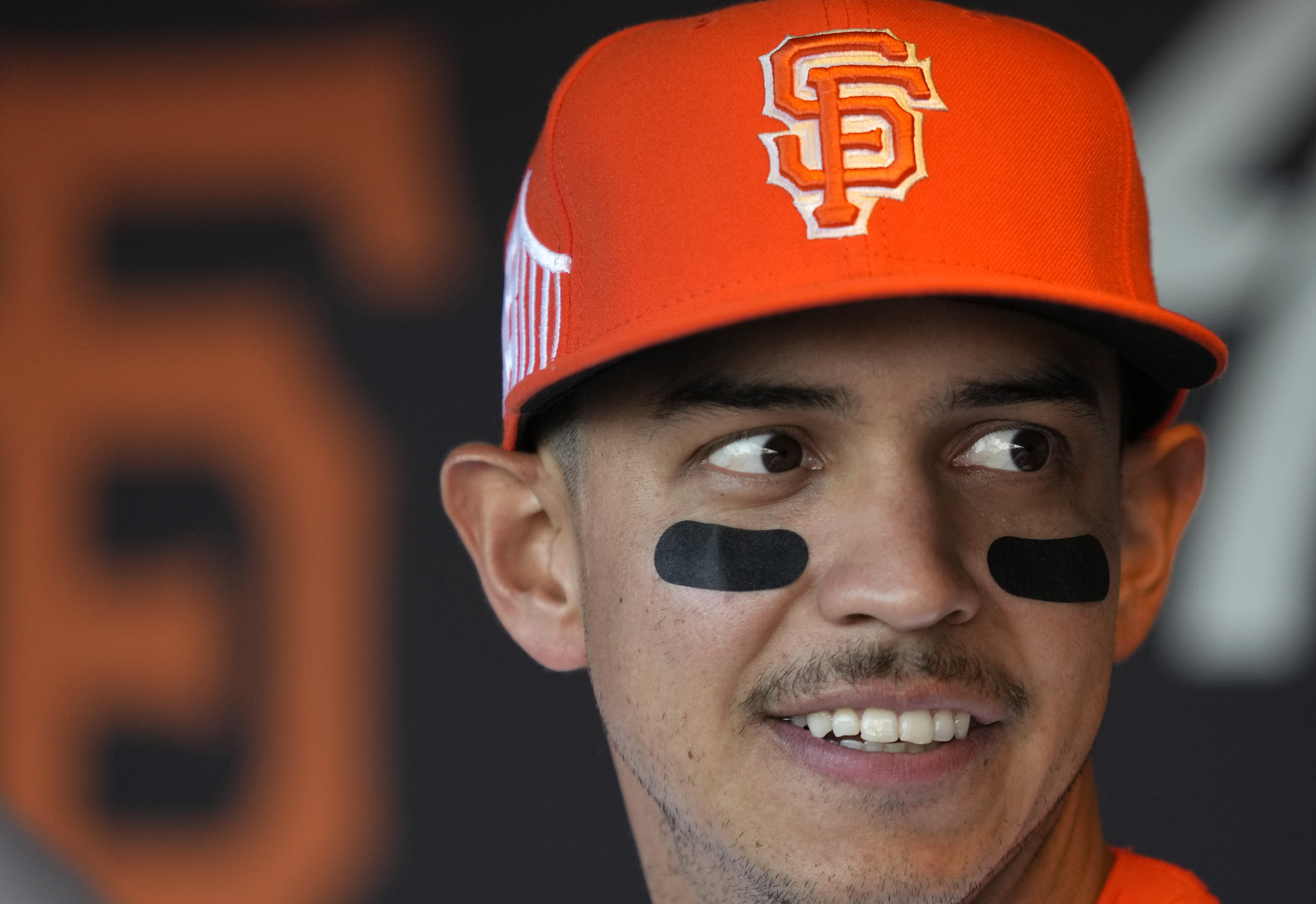 Mauricio Dubón smiling in a Giants hat