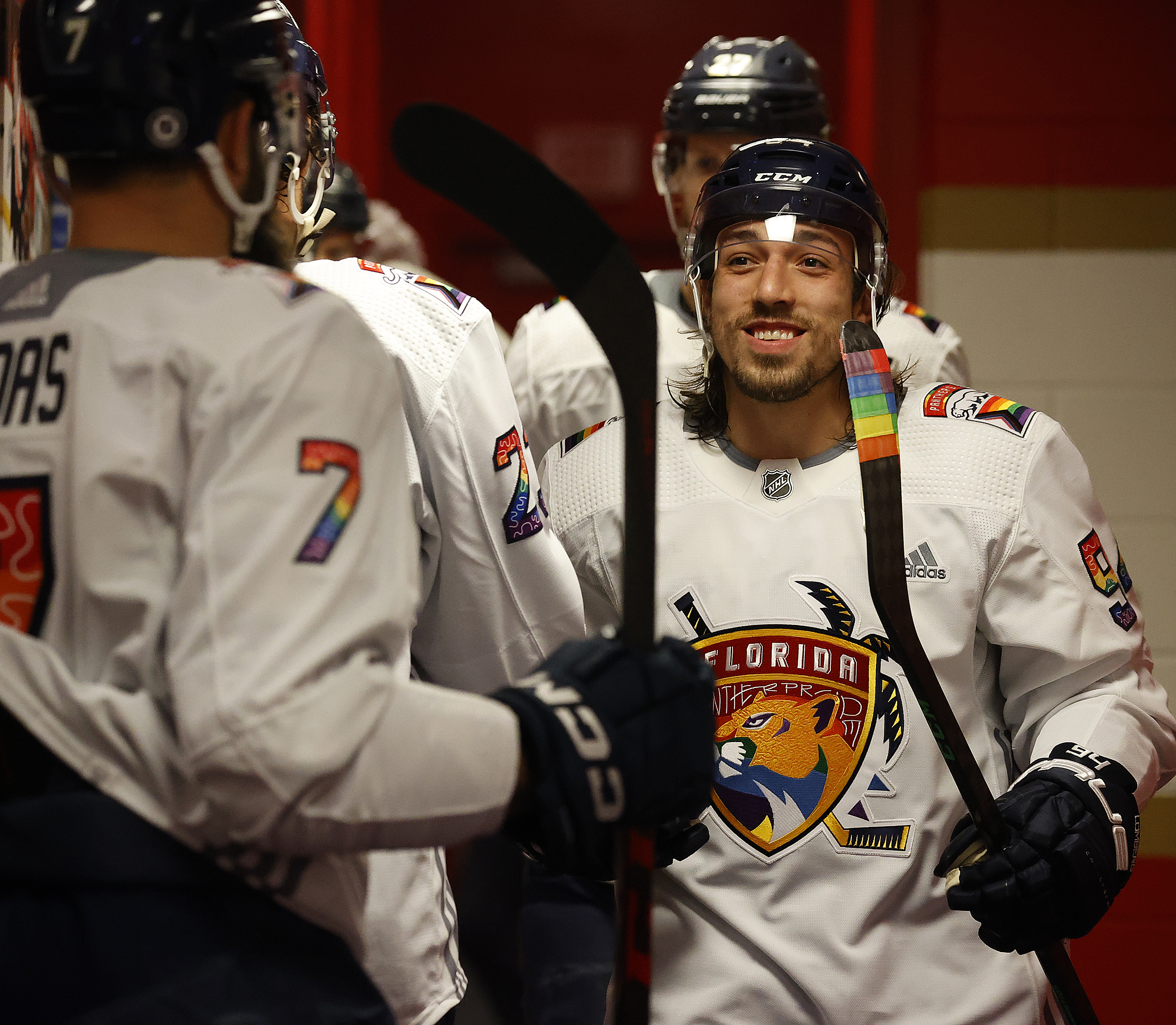 Ryan Lomberg, right, of the Florida Panthers greets teammates before heading out to the ice for warm ups during Pride Night on March 23.