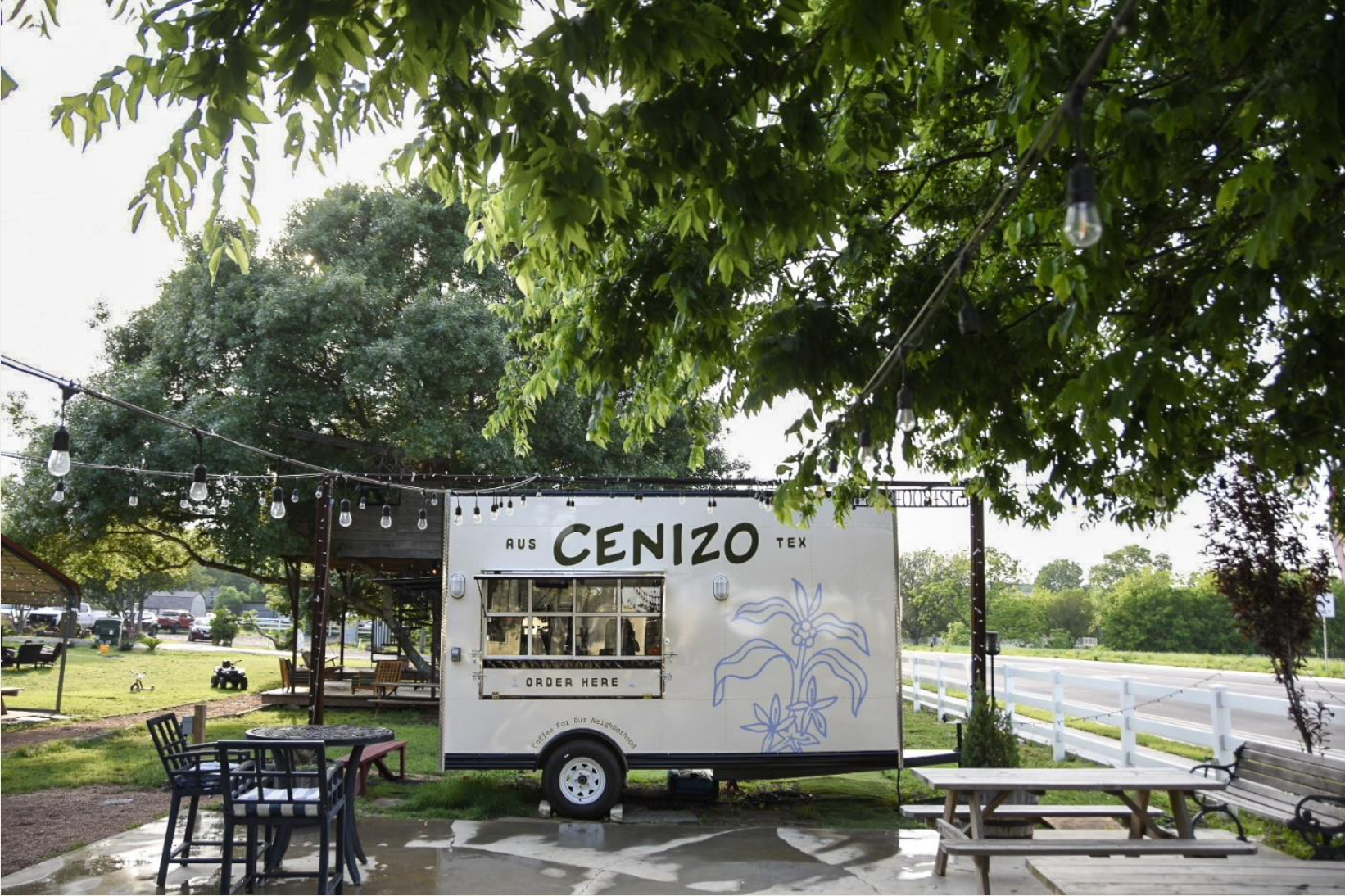 A food truck with a sign reading “Cenizo” parked outside with lots of trees.