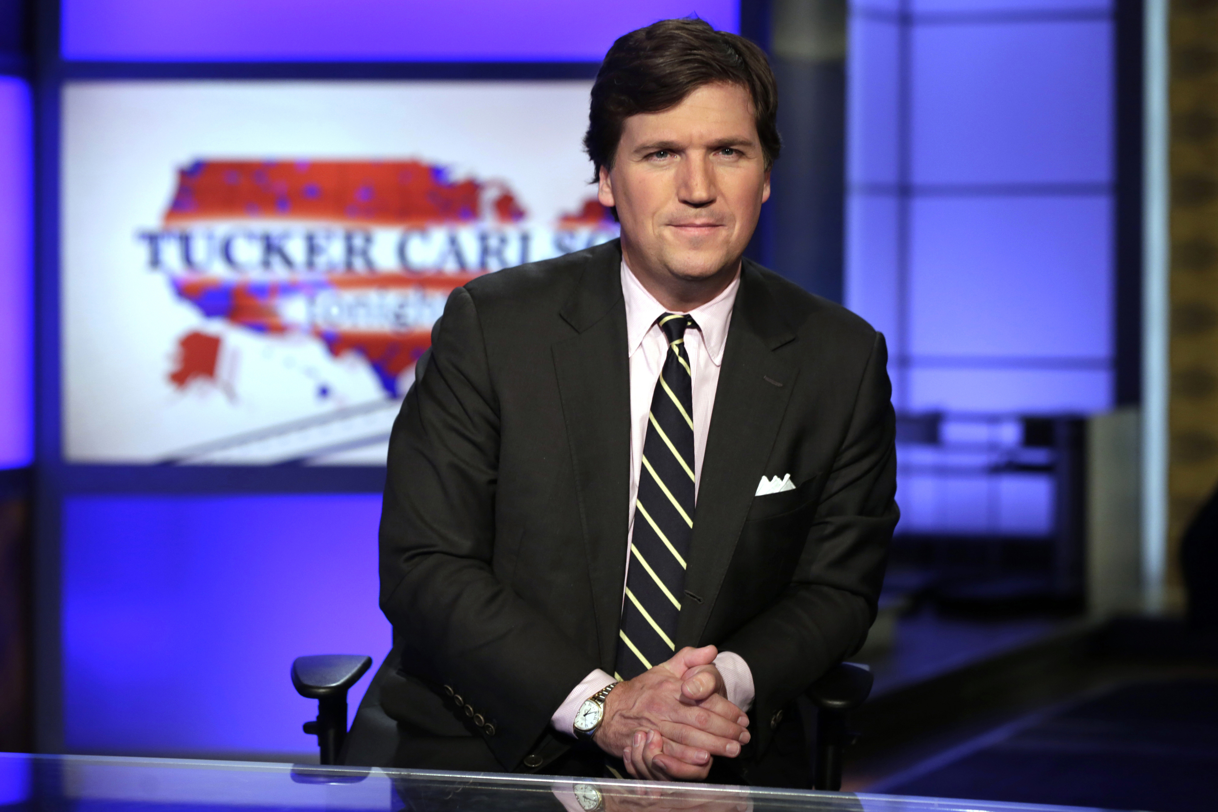 Tucker Carlson poses for photos in a Fox News Channel studio in New York on March 7, 2017.