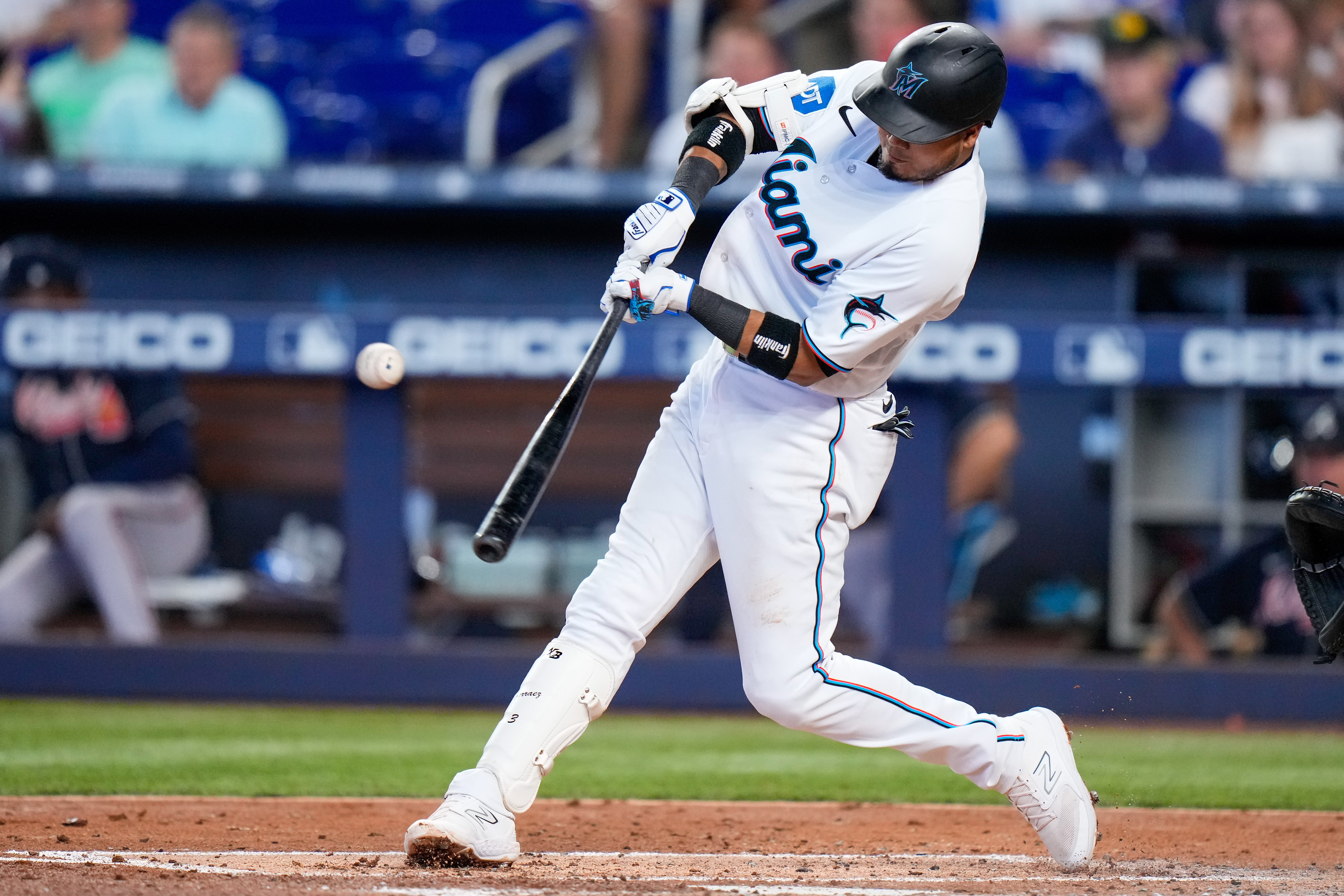 Miami Marlins second baseman Luis Arraez (3) hits a single against the Atlanta Braves during the third inning at loanDepot Park.