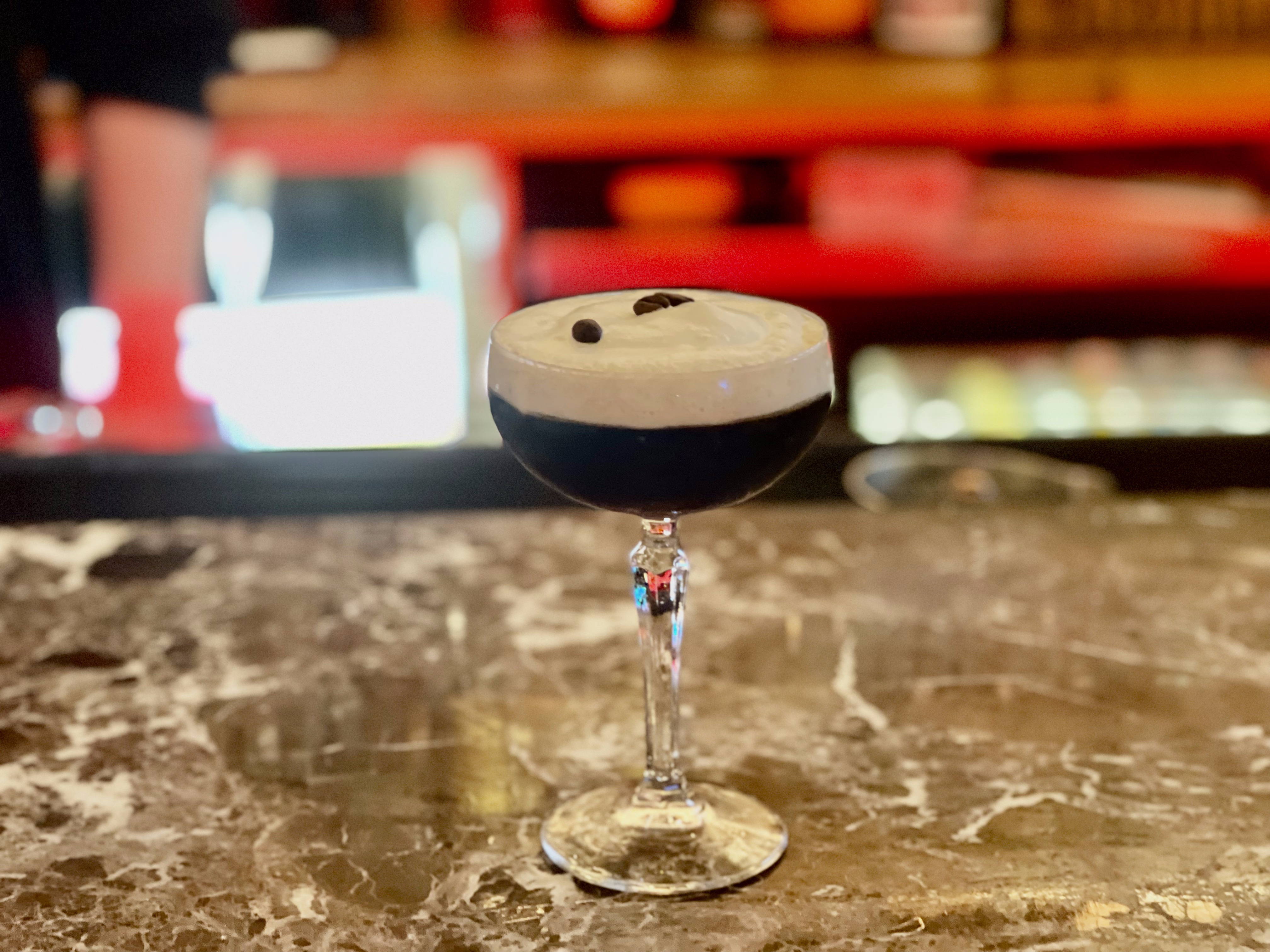 Betelgeuse Betelgeuse’s parmesan espresso martini topped with a cheesy foam and espresso beans, atop a bar.