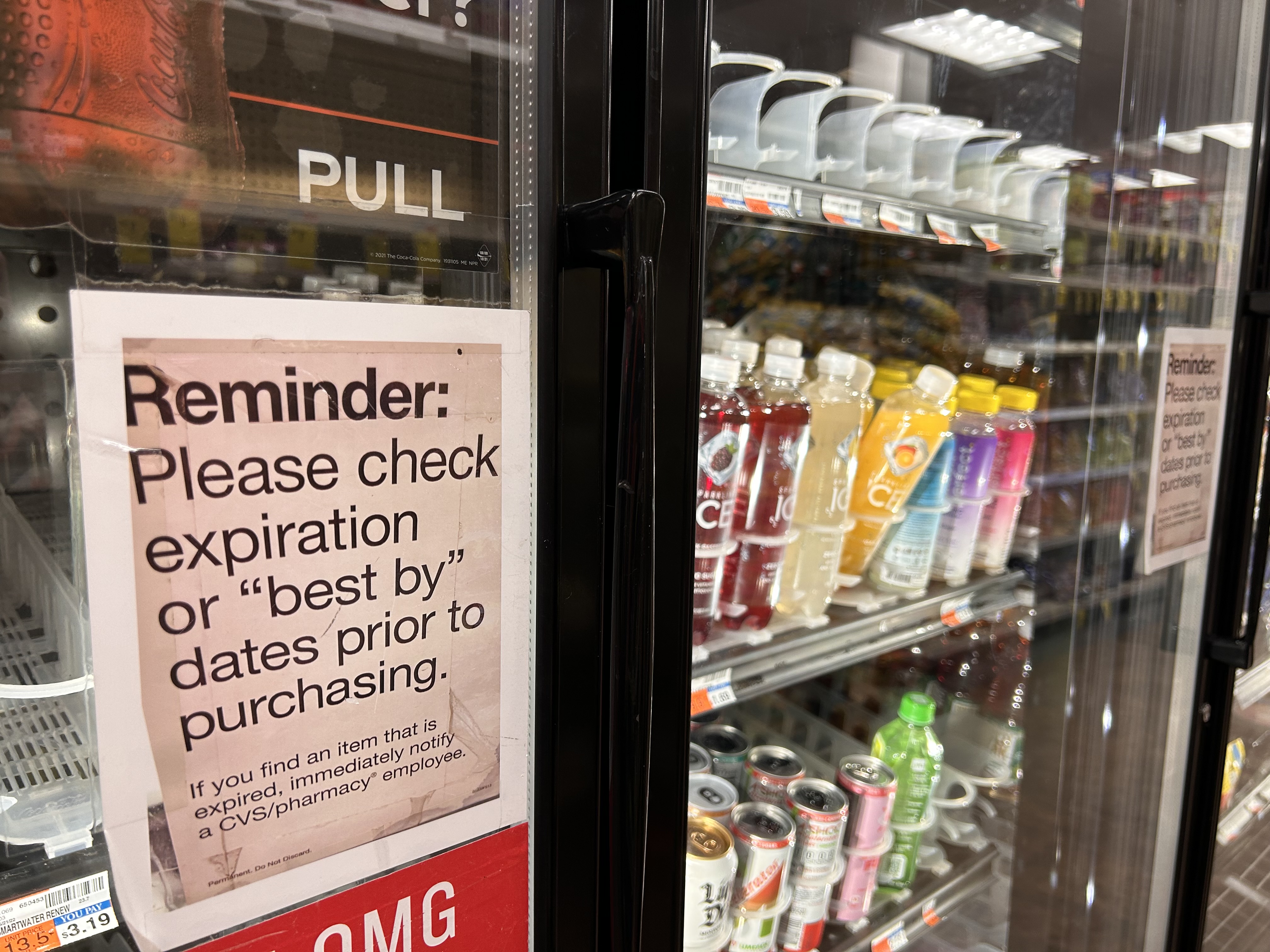 Reminder, Please check expiration or best by dates prior to purchasing sign on refrigerator doors, CVS store, Queens, New York
