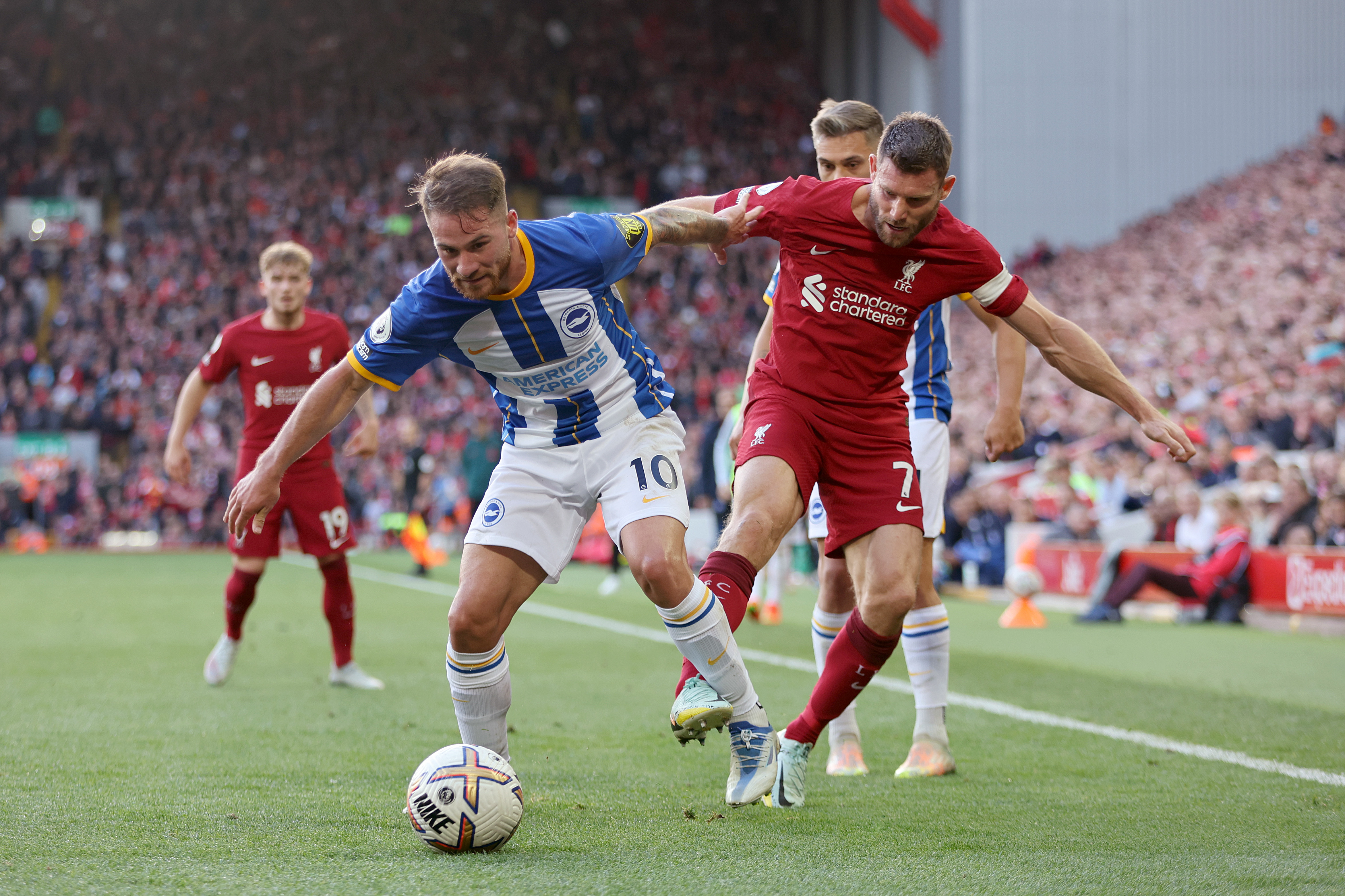 Alexis Mac Allister of Brighton &amp; Hove Albion is challenged by James Milner of Liverpool during the Premier League match between Liverpool FC and Brighton &amp; Hove Albion at Anfield on October 01, 2022 in Liverpool, England.