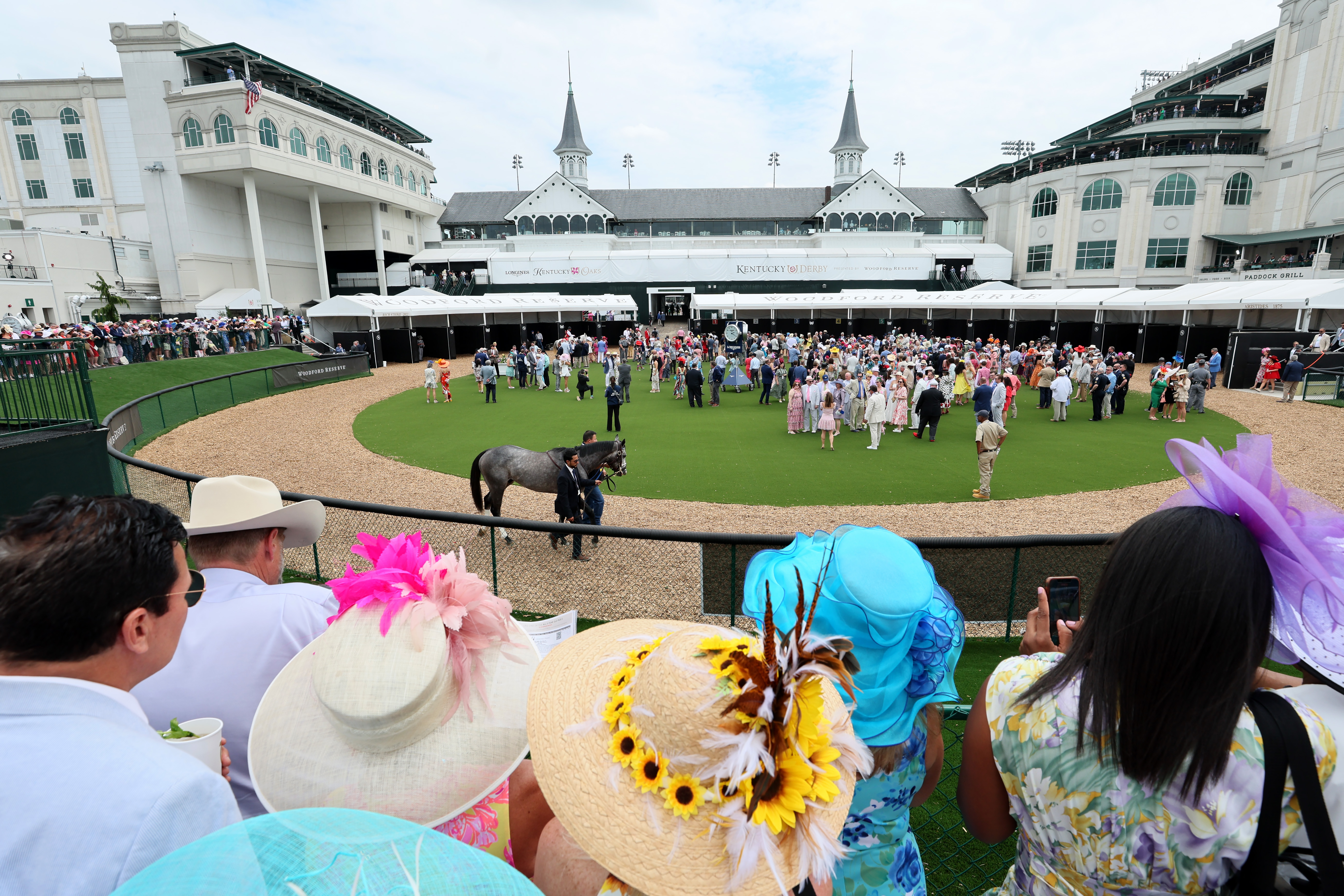 Spectators look on as horses are walked in the paddock during an undercard race before the 149th Kentucky Derby at Churchill Downs on May 06, 2023 in Louisville, Kentucky.