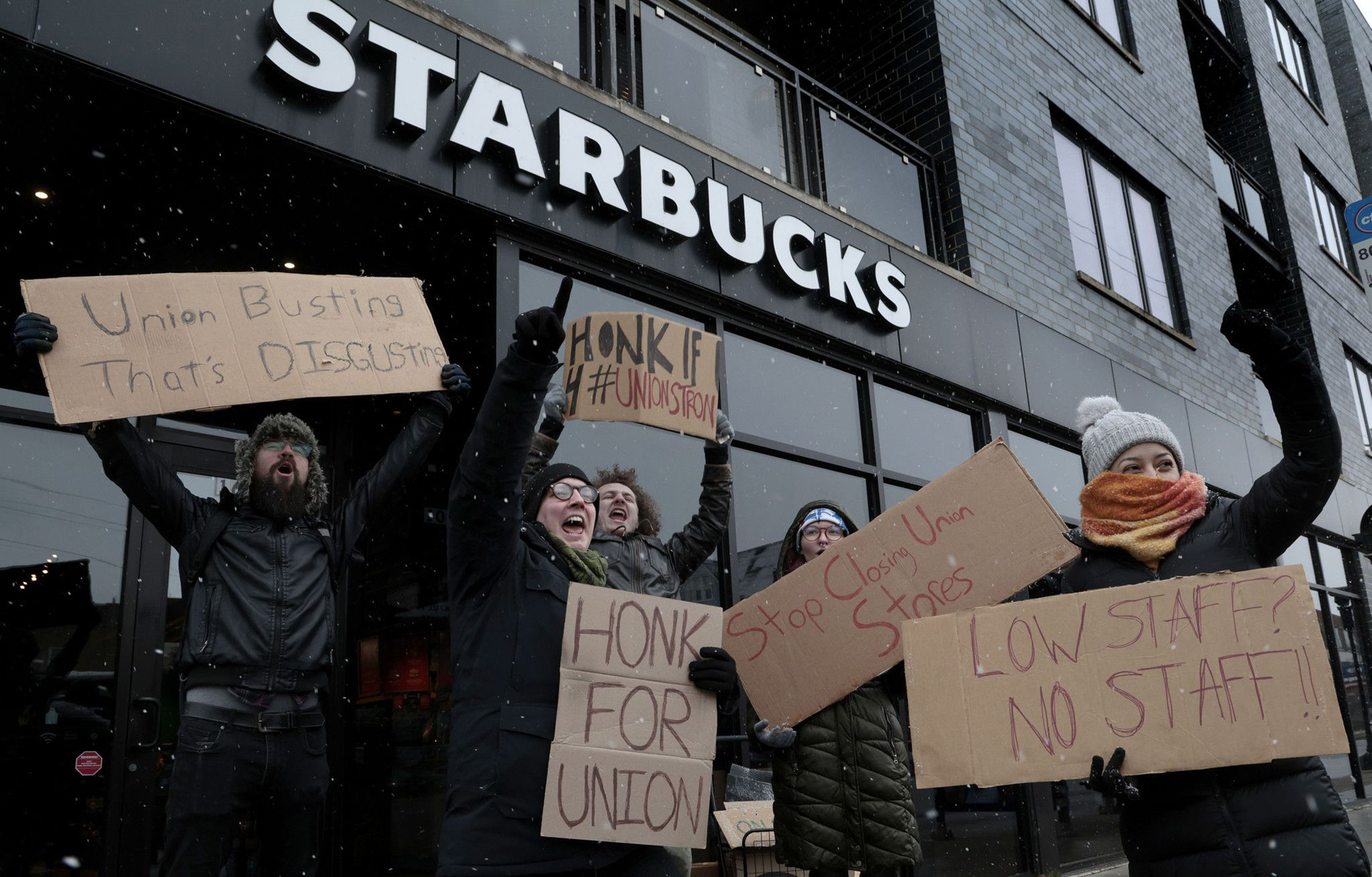People picket outside of a Starbucks