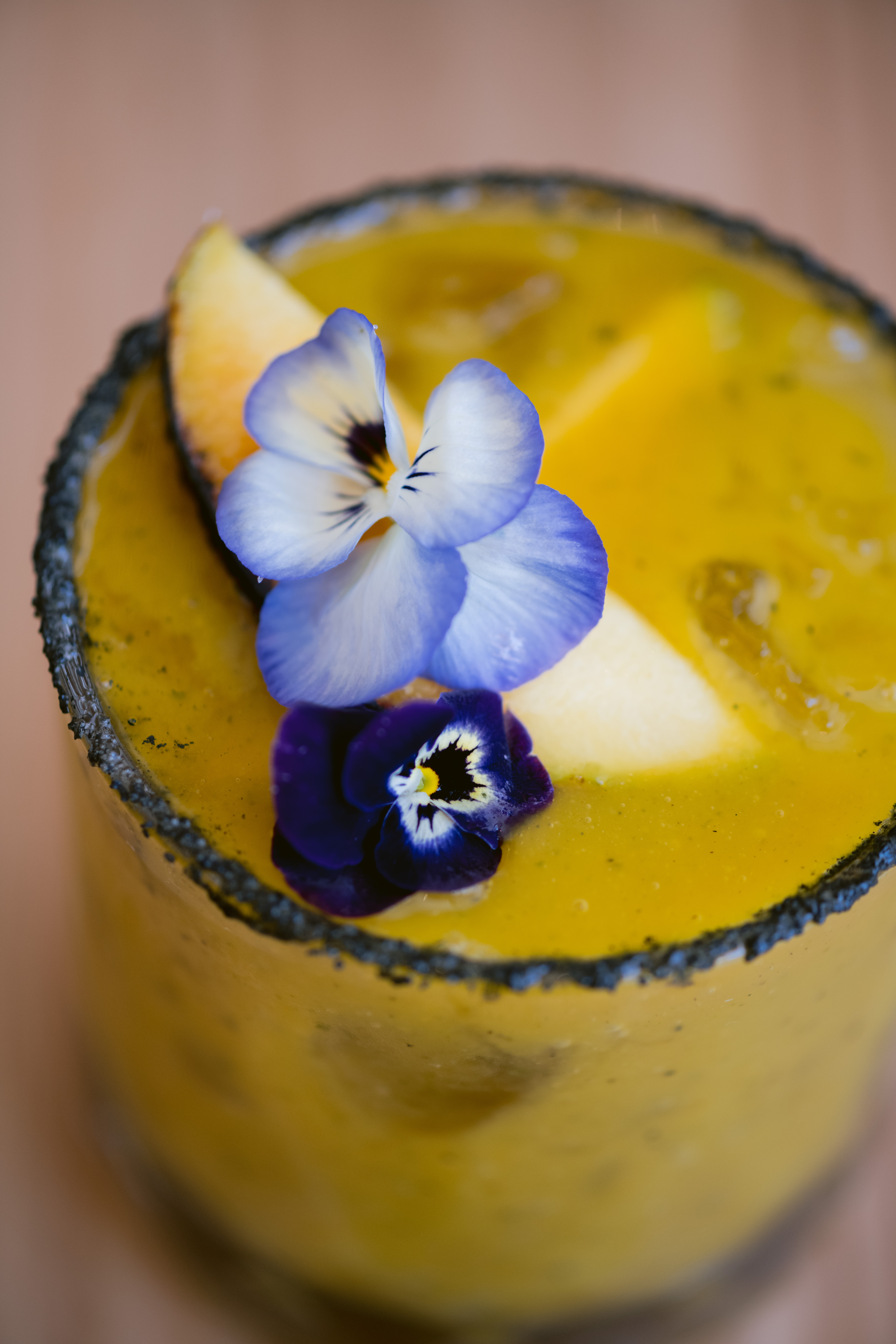 A cocktail garnished with flowers. 