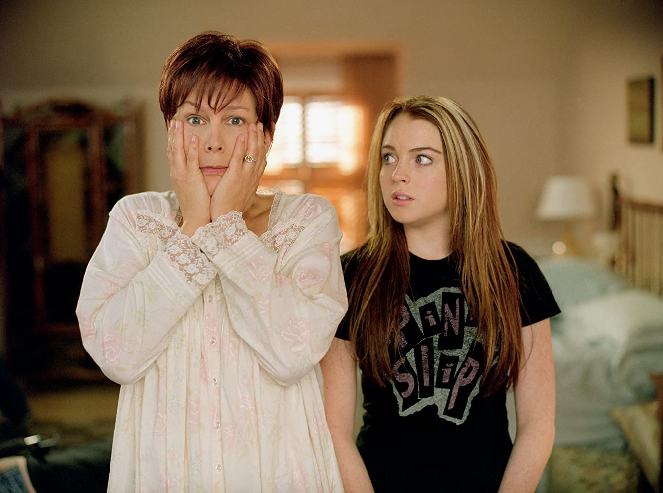 Jamie Lee Curtis clutches her face while Lindsay Lohan looks on in a screenshot from Freaky Friday