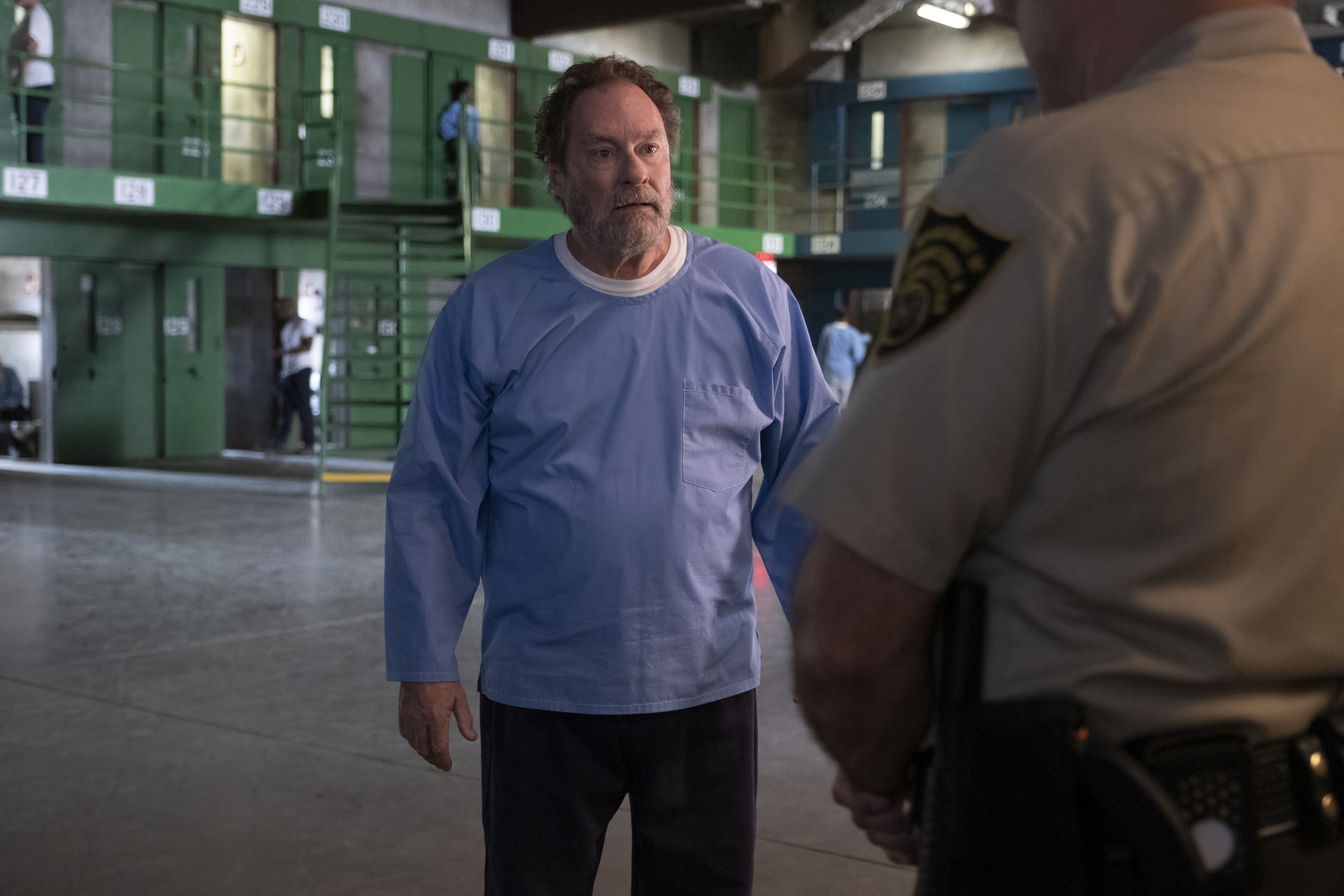 Fuches (Stephen Root) stands and talks to a guard in a still from Barry season 4