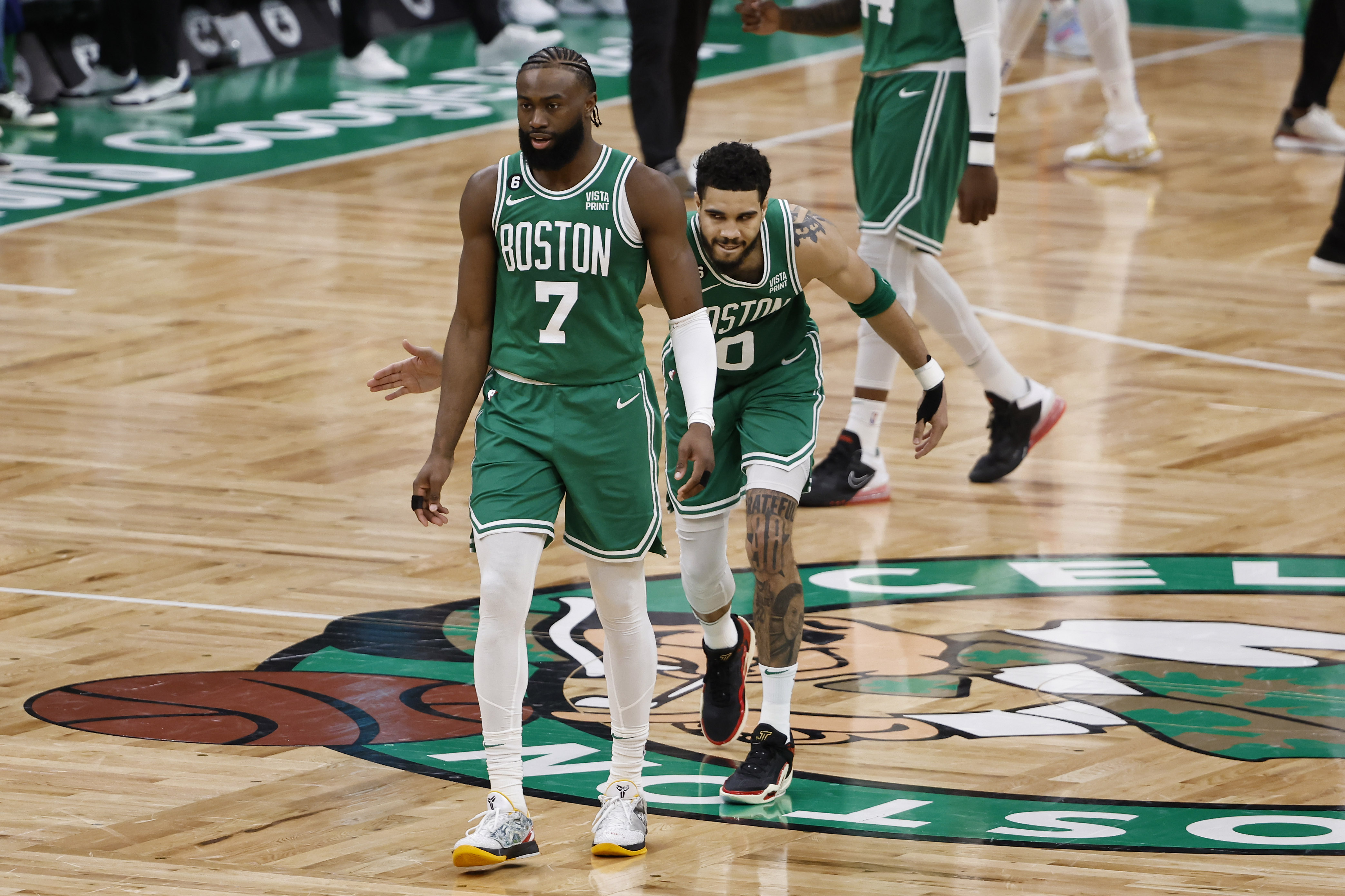 Boston Celtics forward Jayson Tatum (0) pats guard Jaylen Brown (7) after a basket against the Philadelphia 76ers during the second half of game seven of the 2023 NBA playoffs at TD Garden.