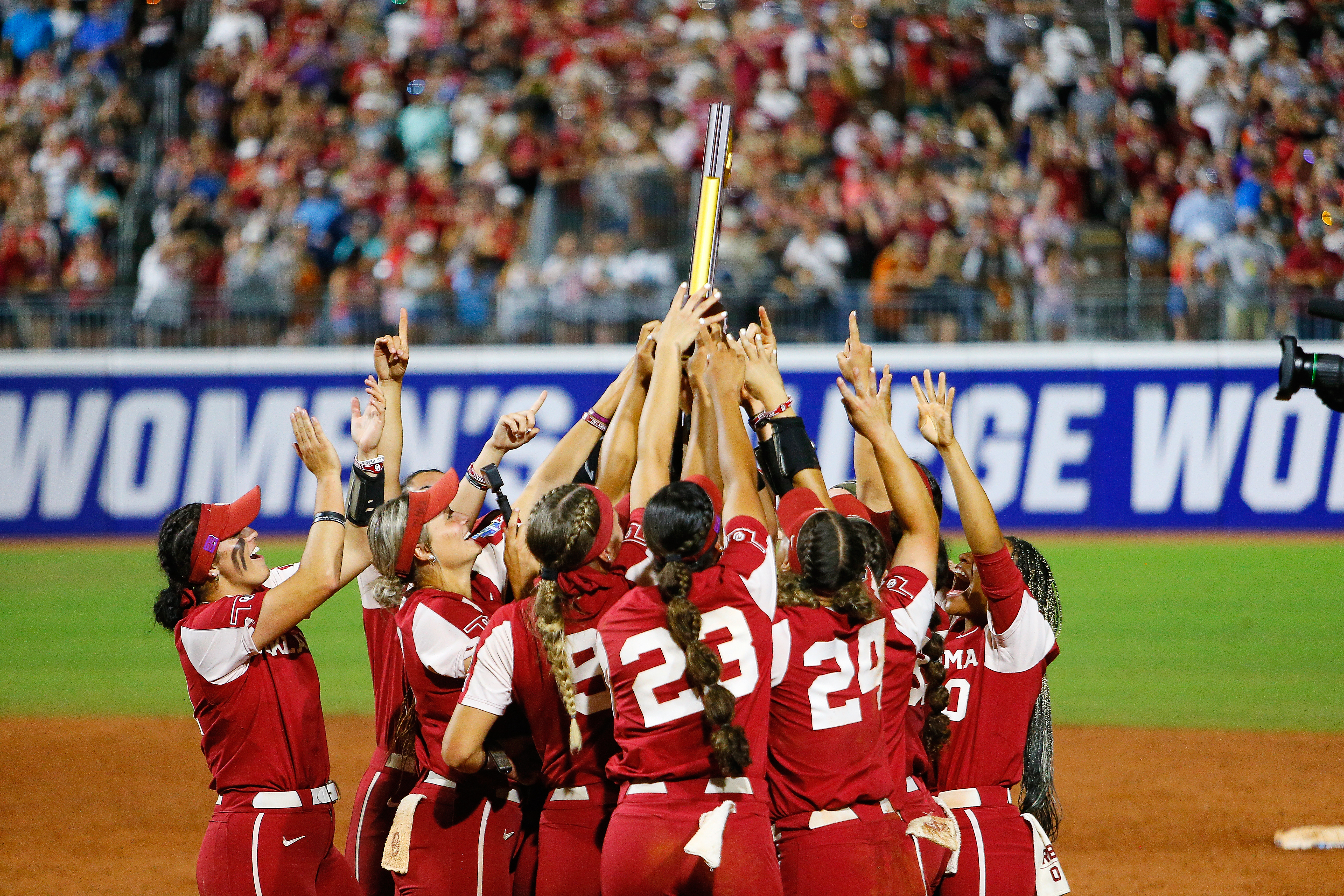 The Oklahoma Sooners lift up the NCAA trophy as they celebrate their championship win over the Texas Longhorns during the NCAA Women’s College World Series finals at the USA Softball Hall of Fame Complex on June 9, 2022 in Oklahoma City, Oklahoma. Oklahoma won the NCAA Championship with the 10-5 victory.