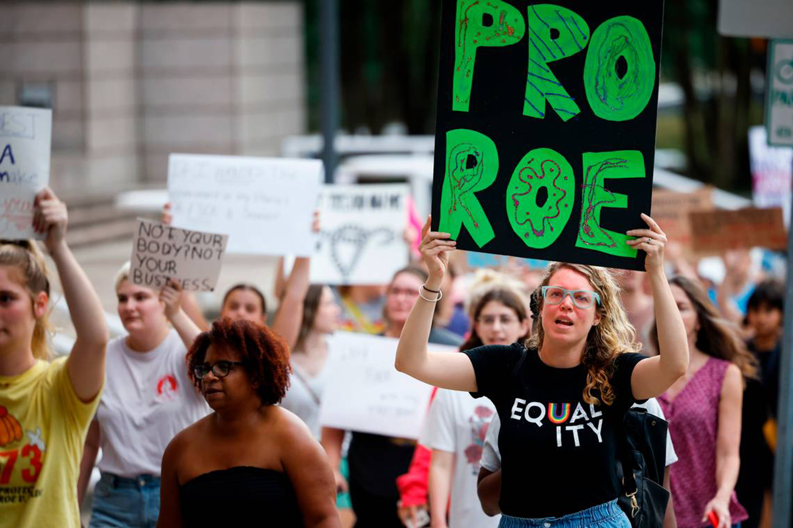 People hold signs supporting abortion rights. 