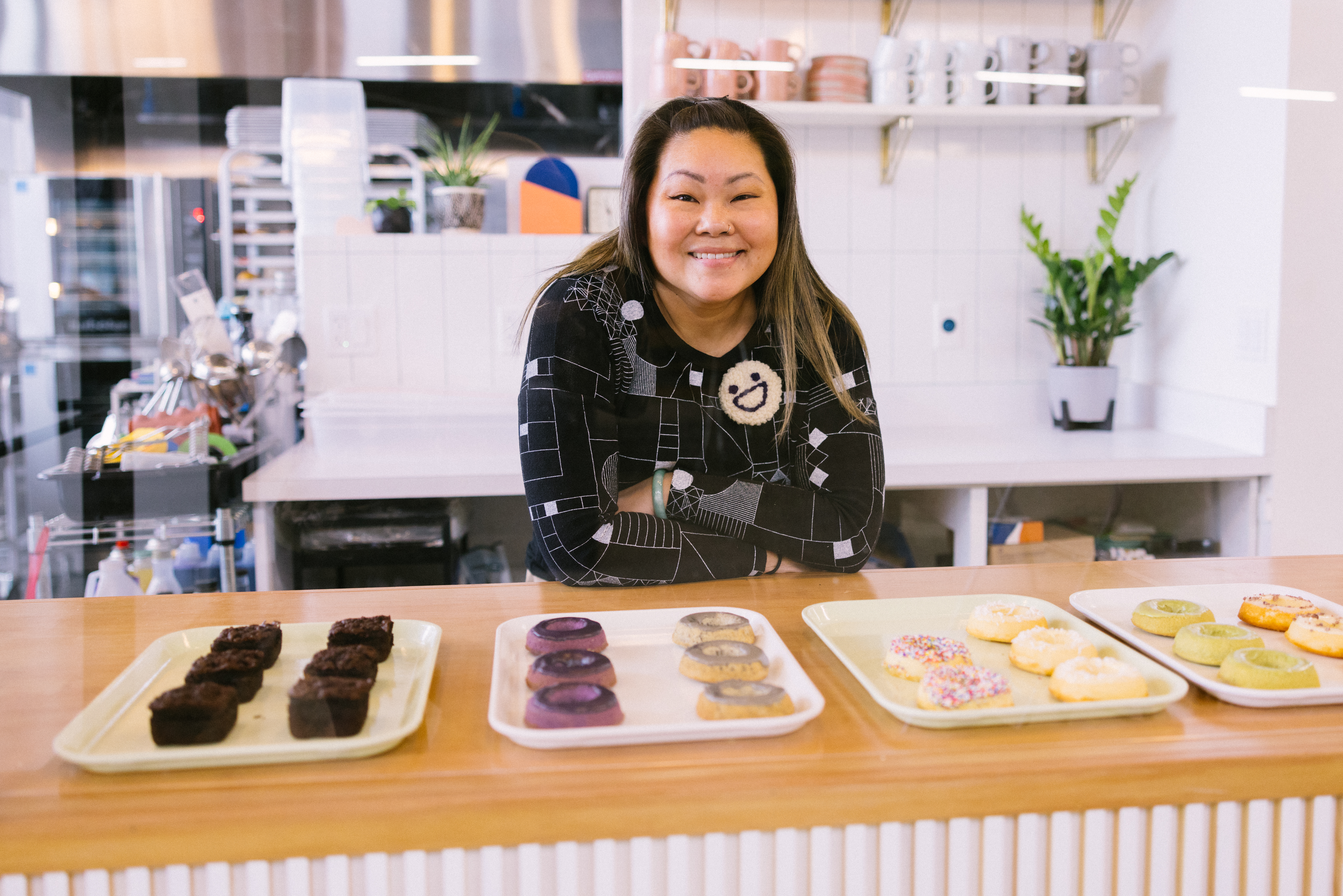 Lisa Nguyen stands in front of the doughnut display at Heyday.