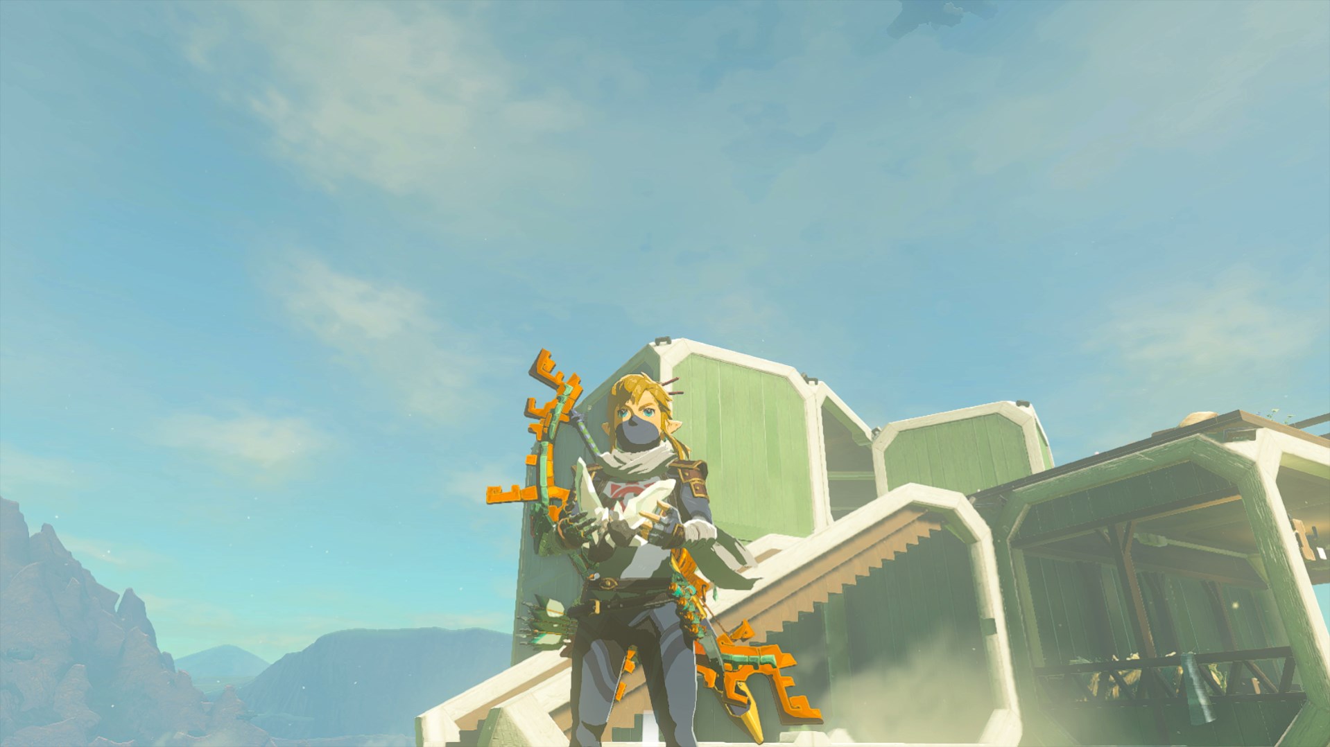 Link, in his stealth armor, happily holds up two diamonds in Tears of the Kingdom.
