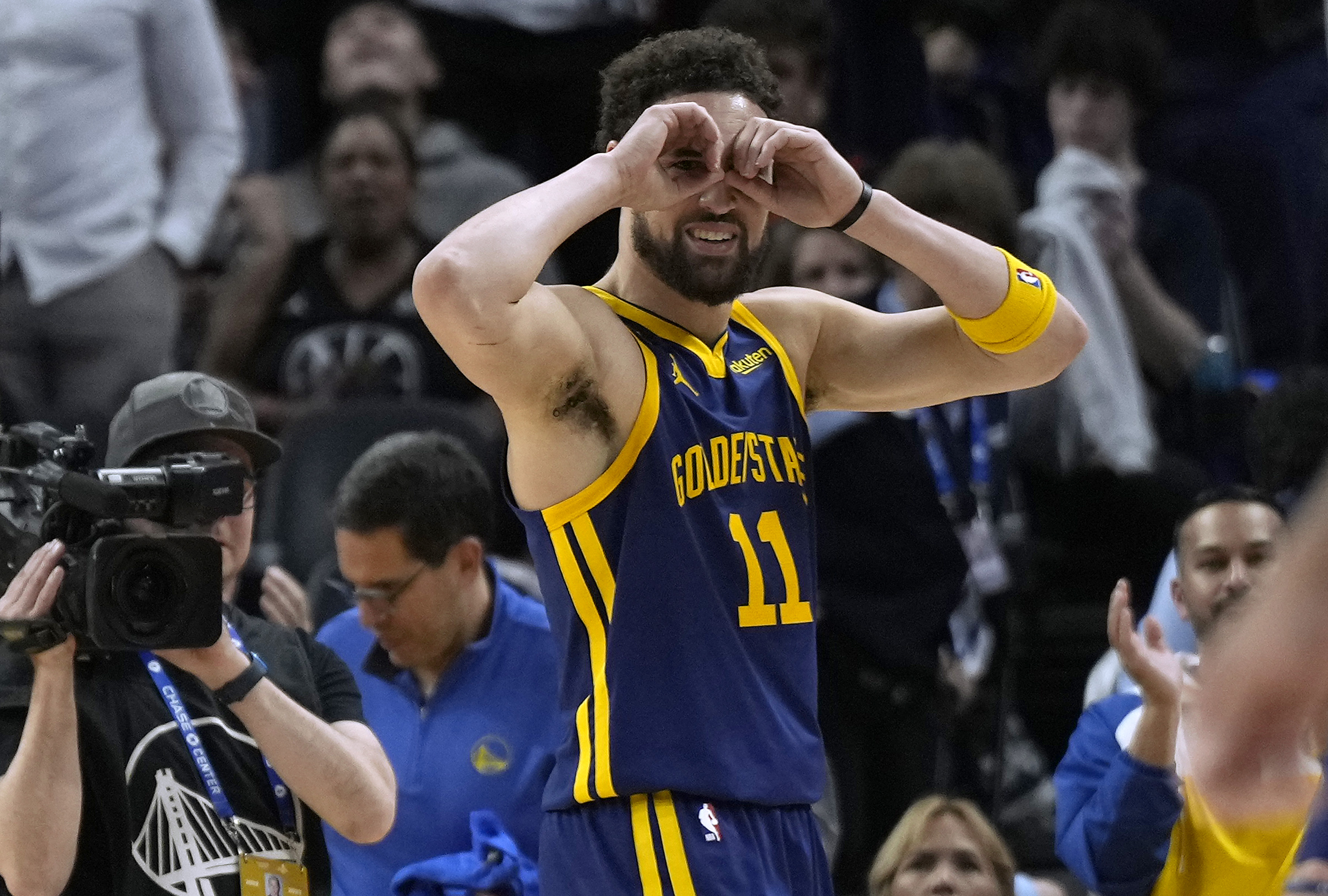 Klay Thompson holding his hands over his eyes like goggles