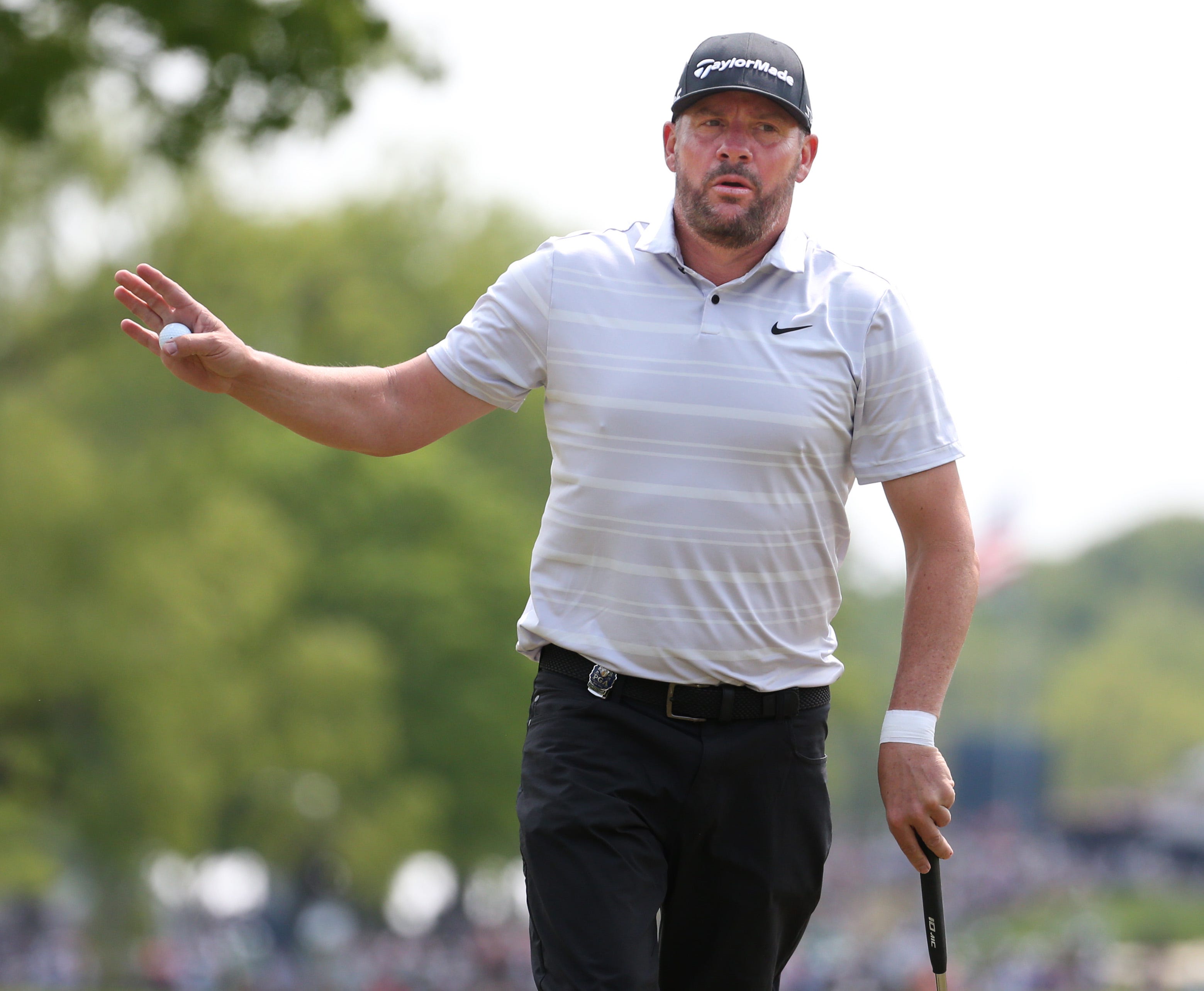Michael Block waves to fans after his par putt on the 4th hole during the final round at the PGA Championship at Oak Hill Country Club Sunday, May 21, 2023.