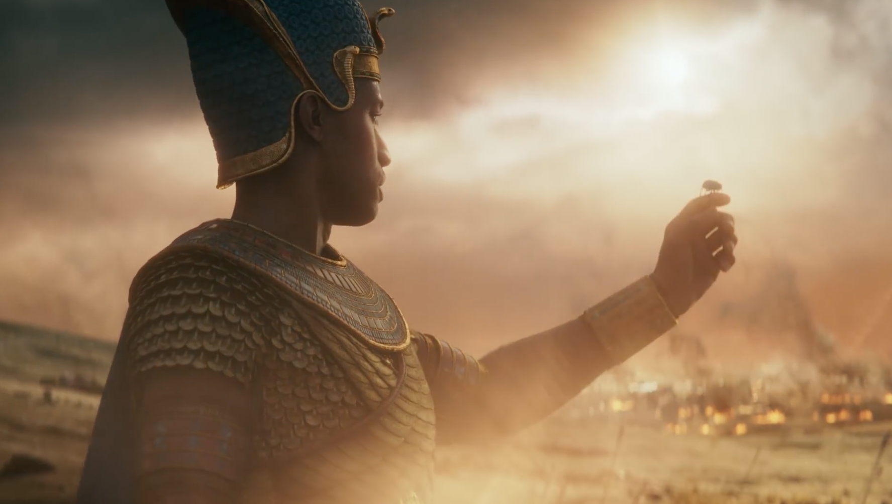 A pharaoh in Total War: Pharaoh, holding a scarab beetle up to the sky.