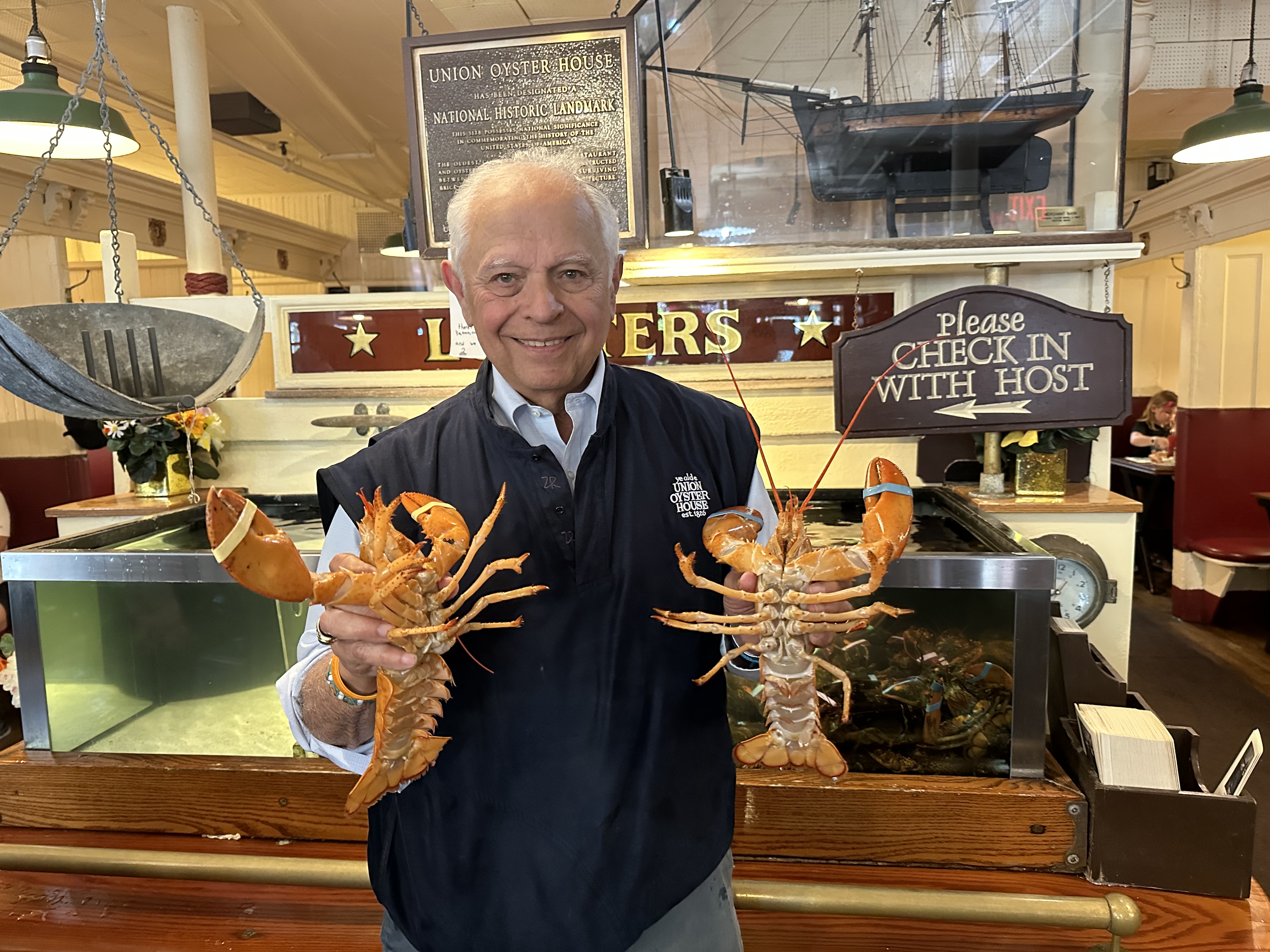 Joseph Milano holds two lobsters. 