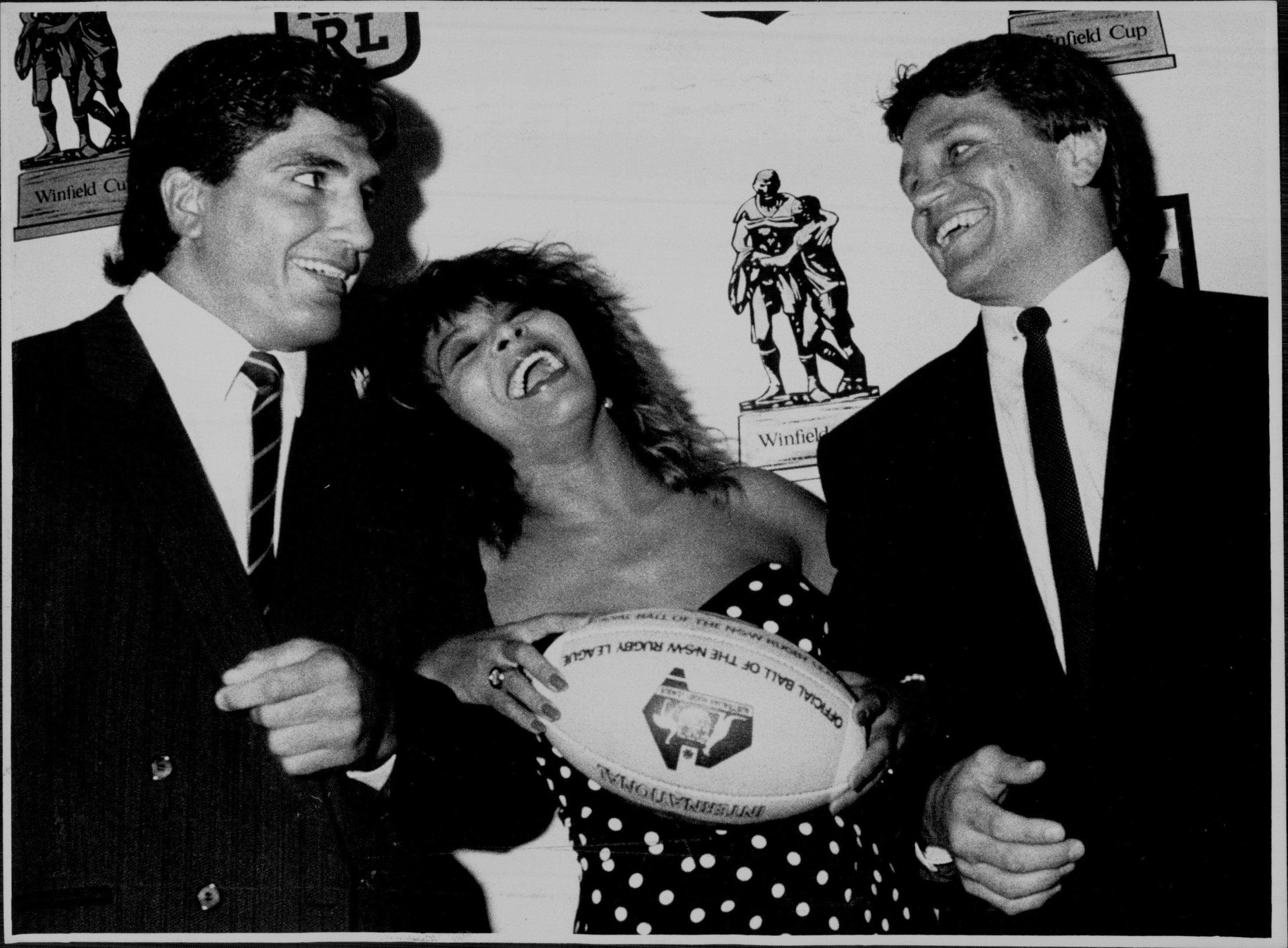 Tina Turner at A Press Conference at The Intercontinental Hotel for the promotion of The Rugby League.Tina Turner with Balmain Captain Wayne Pearce. And Mario French.