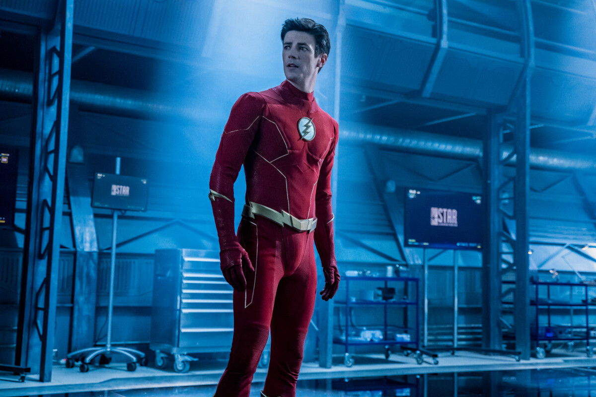 Grant Gustin as the Flash standing and looking shocked in a still from the CW show