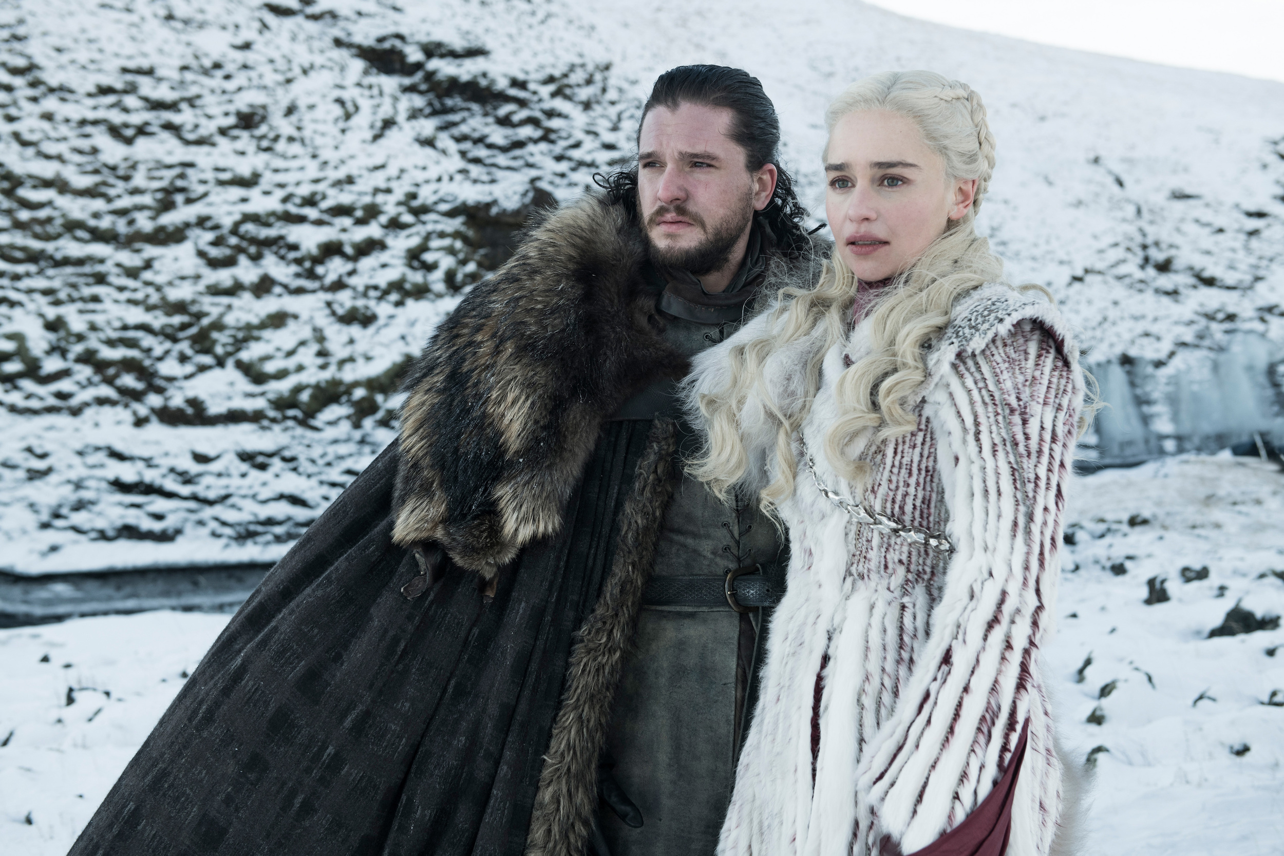 Kit Harington and Emilia Clarke as Jon Snow and Daenerys Targaryen in Game of Thrones. They’re standing in a snowfield, dressed in furs. 