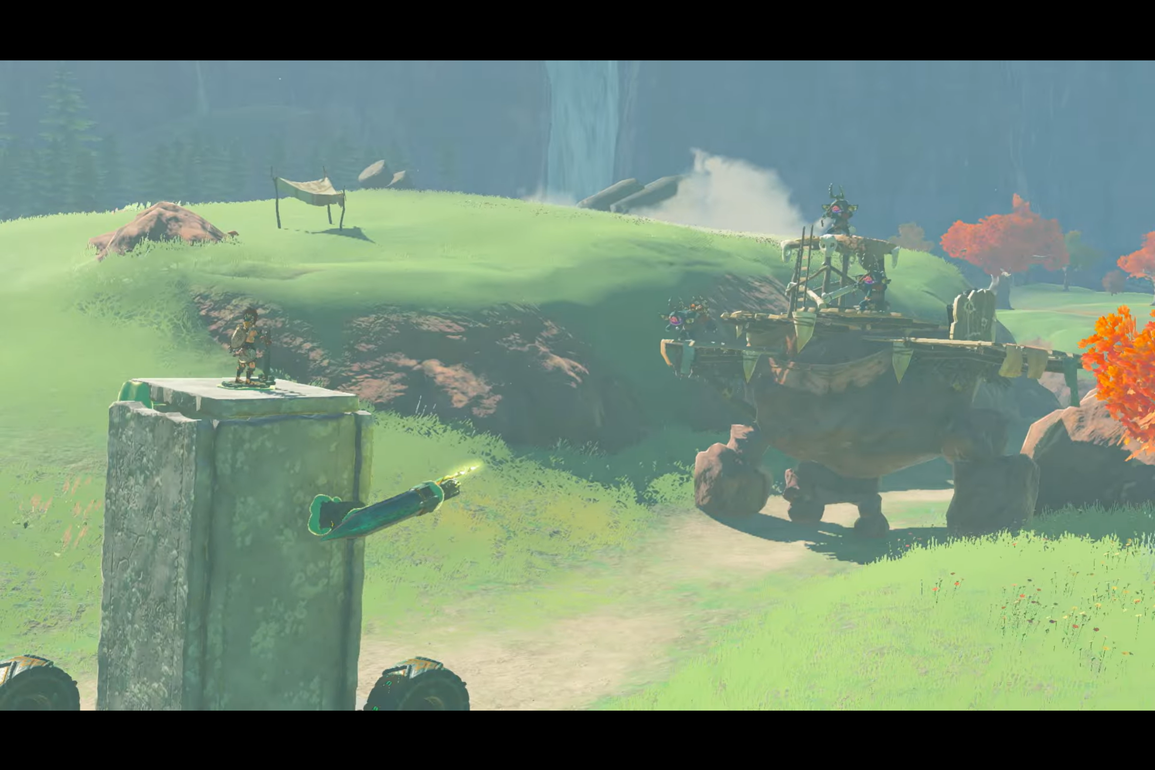 Link commands a janky vehicle made out of a few blocks of stone, fighting Bokoblins riding a stone Talus in The Legend of Zelda: Tears of the Kingdom.