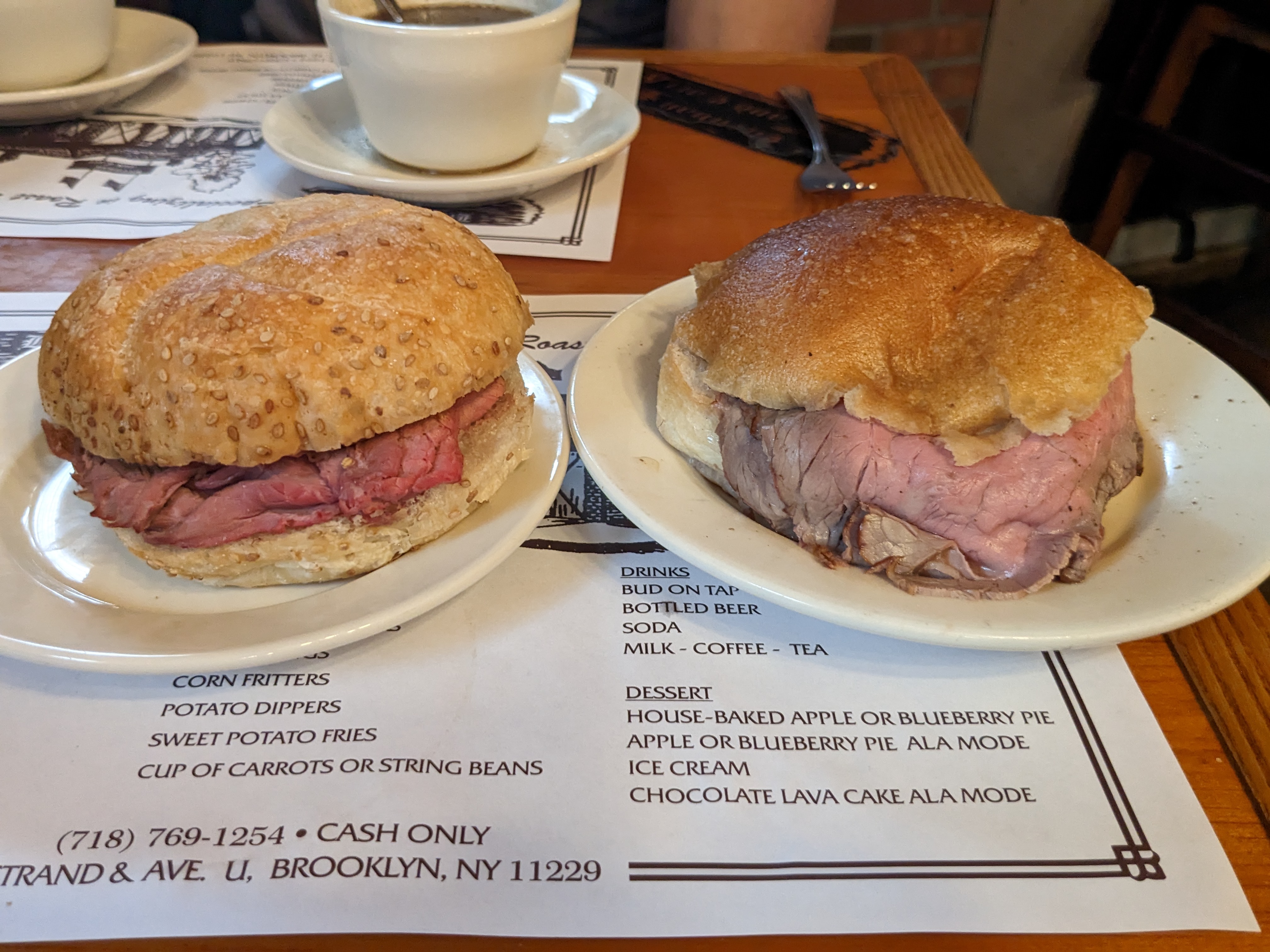 Two sandwiches side by side on Kaiser rolls.