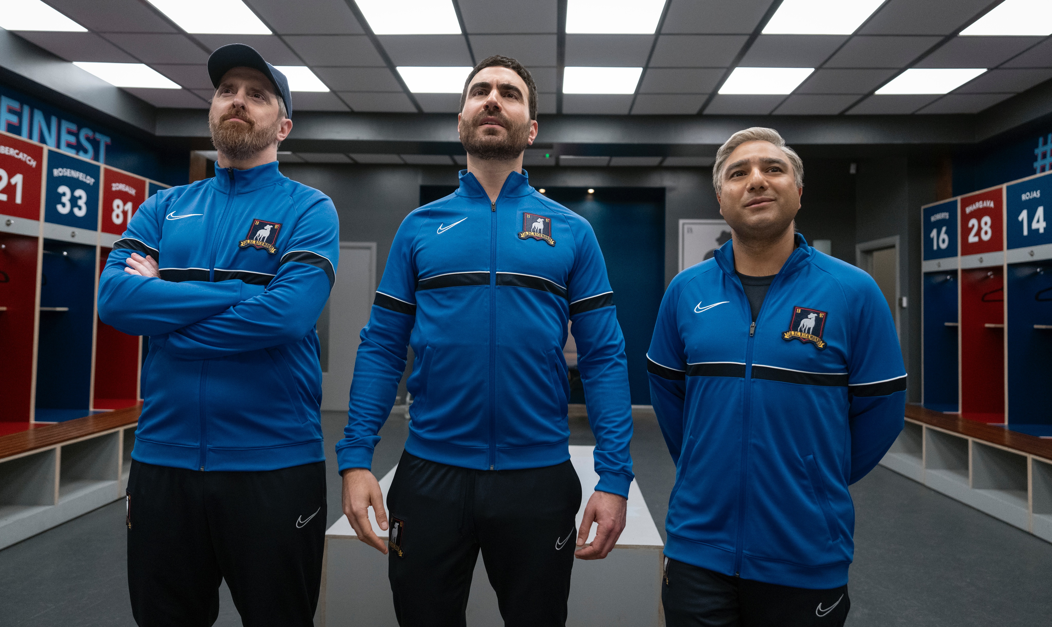 Beard, Roy, and Nate stand in the Richmond locker room in their new coaching uniforms 
